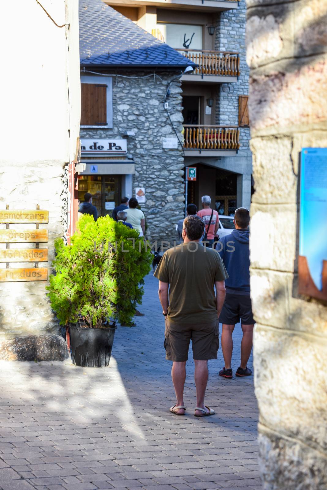 Alp, Spain : 2020 19 July : People buy bread behind after covid19 the Church of Parròquia de Sant Pere in Summer. Alp, Spain  on July 2020.