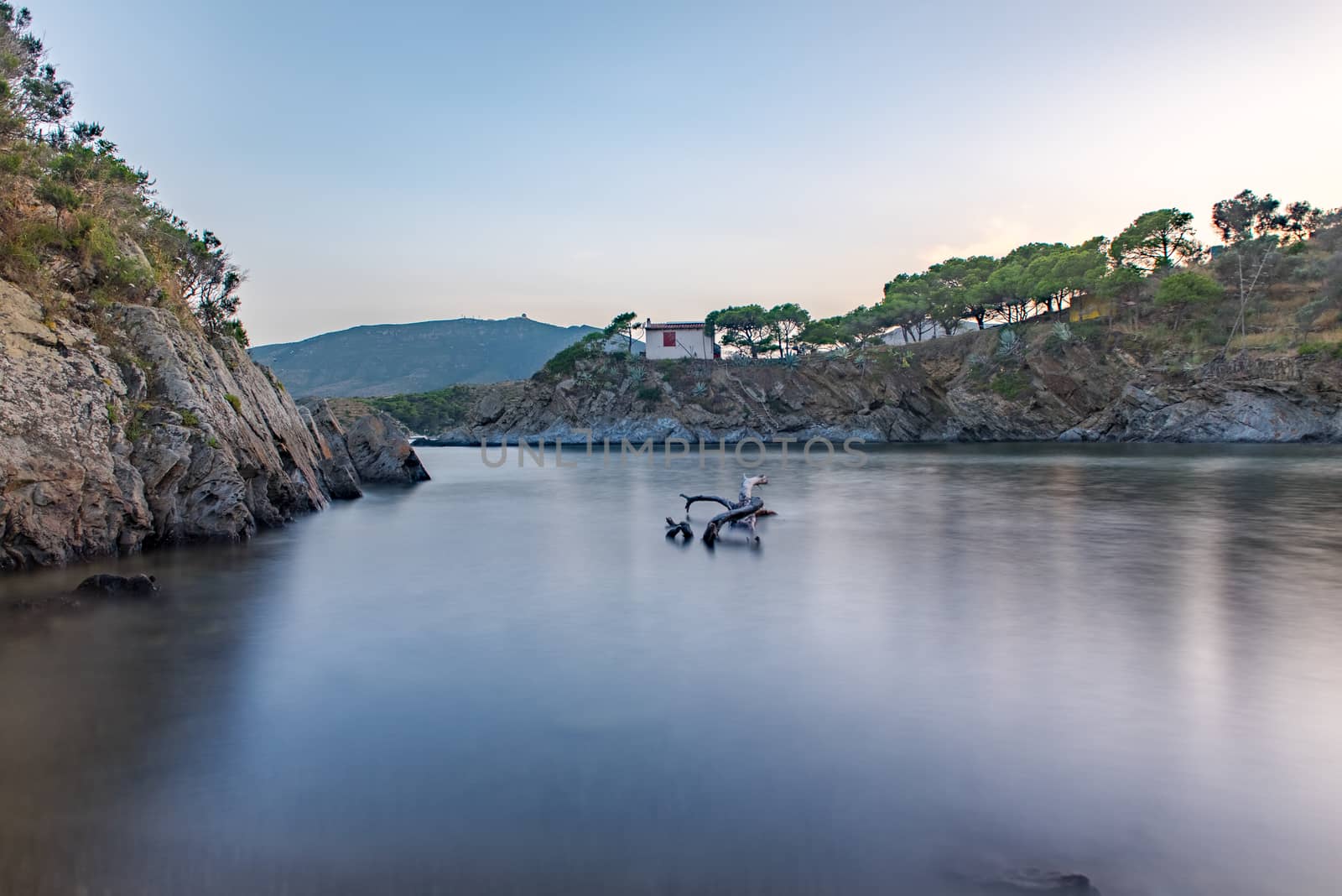 Cadaques, Spain :  2020 08 July : Spain Costa Brava peaceful pebble beach of the Mediterranean sea, Cala Guillola, Cadaques, Cap de Creus, Catalonia.