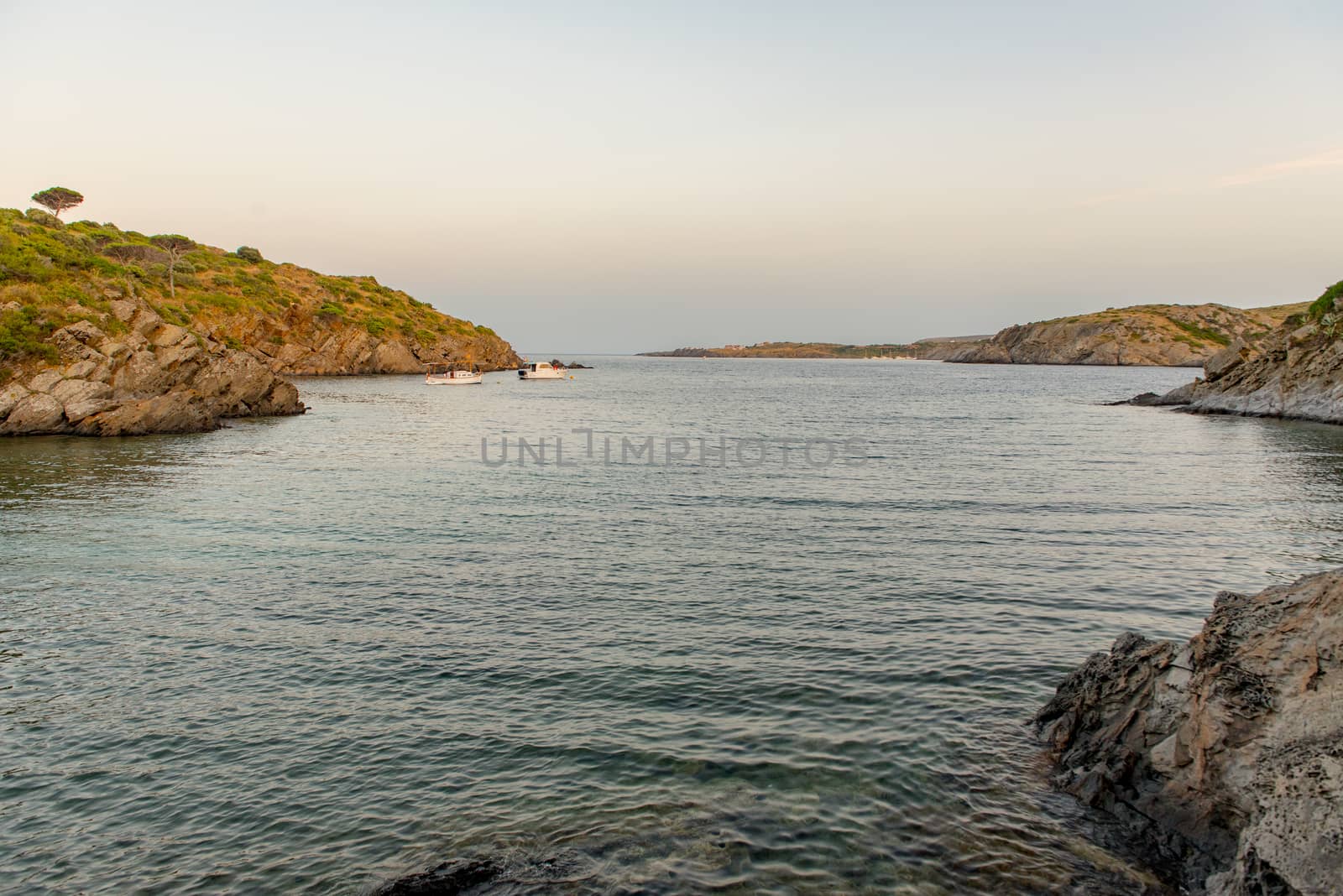 Cadaques, Spain :  2020 08 July : Spain Costa Brava peaceful pebble beach of the Mediterranean sea, Cala Guillola, Cadaques, Cap de Creus, Catalonia.