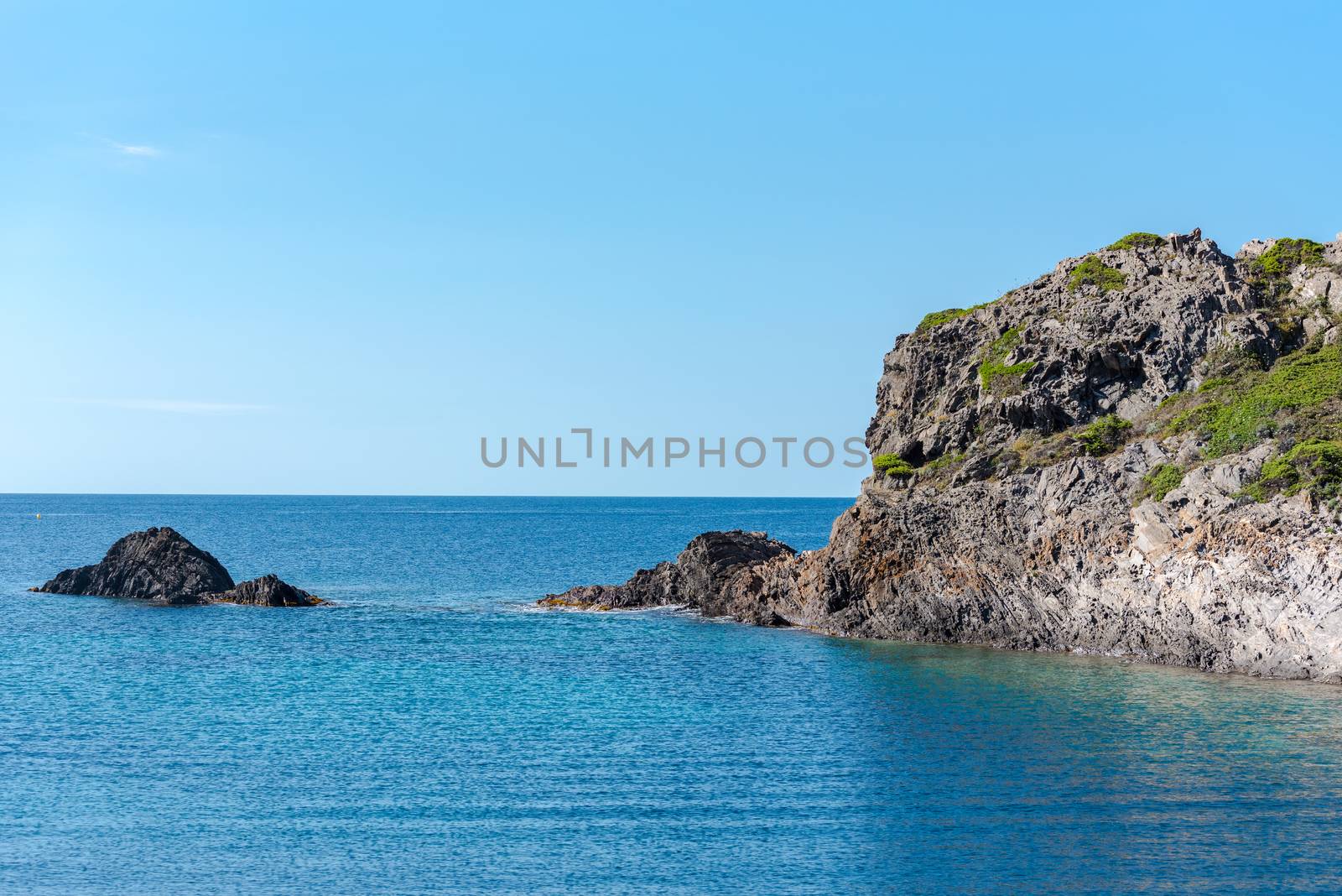 Sea landscape with Cap de Creus, natural park. Eastern point of Spain, Girona province, Catalonia. Famous tourist destination in Costa Brava. Sunny summer day with blue sky and clouds.