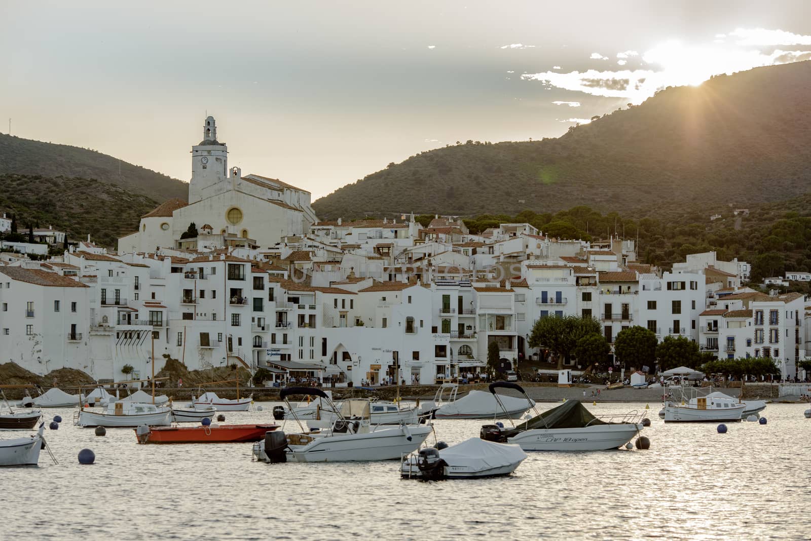 Boats in the beach and houses of the village of Cadaques, Spain  by martinscphoto