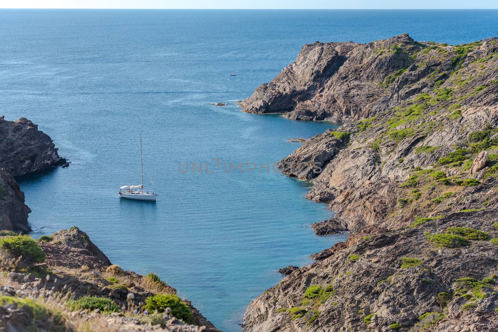 Sea landscape with Cap de Creus, natural park. Eastern point of Spain, Girona province, Catalonia. Famous tourist destination in Costa Brava. Sunny summer day with blue sky and clouds.