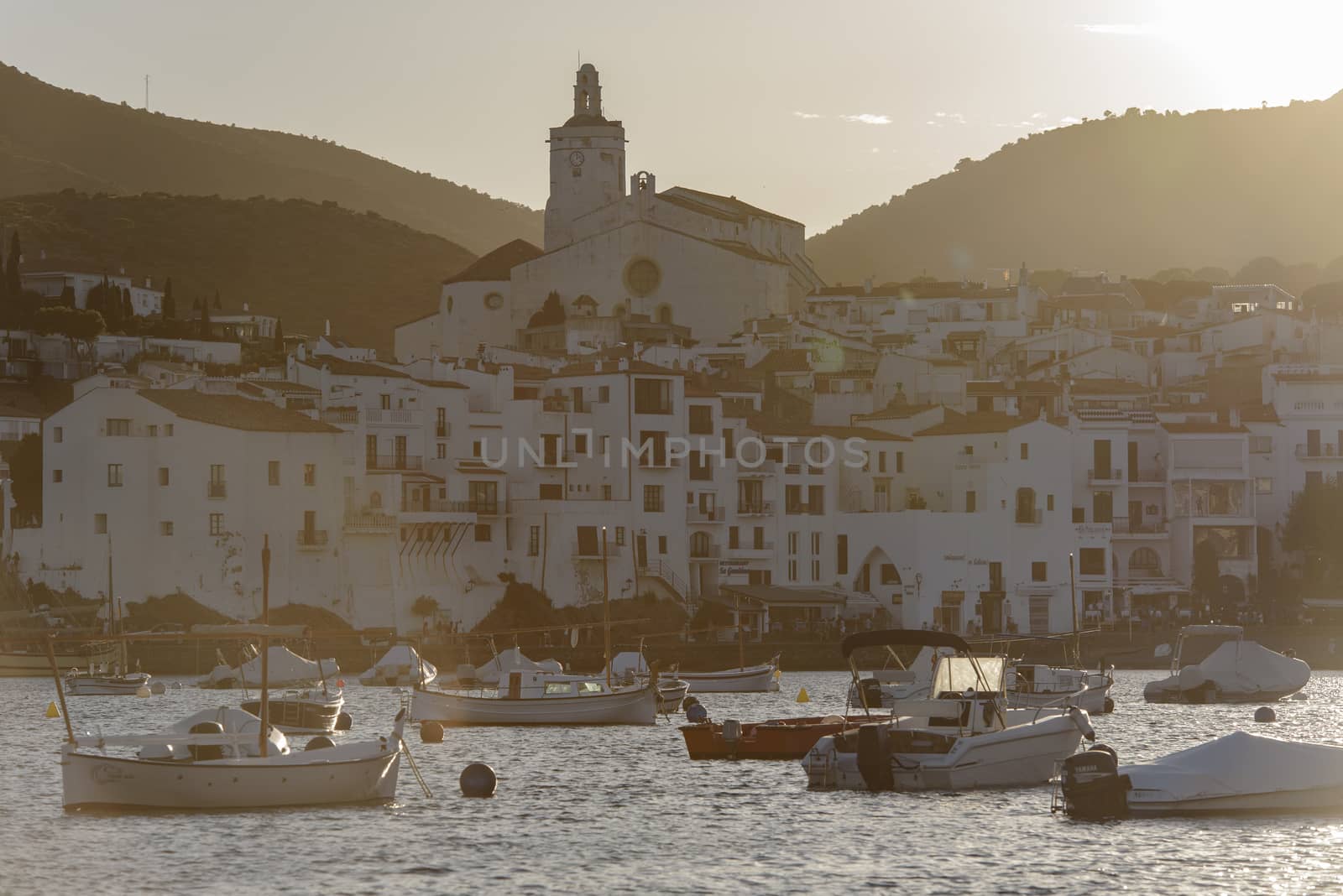 Cadaques, Spain : 07 JULY 2020 : Boats in the beach and houses of the village of Cadaques, Spain in summer on 07 july 2020.