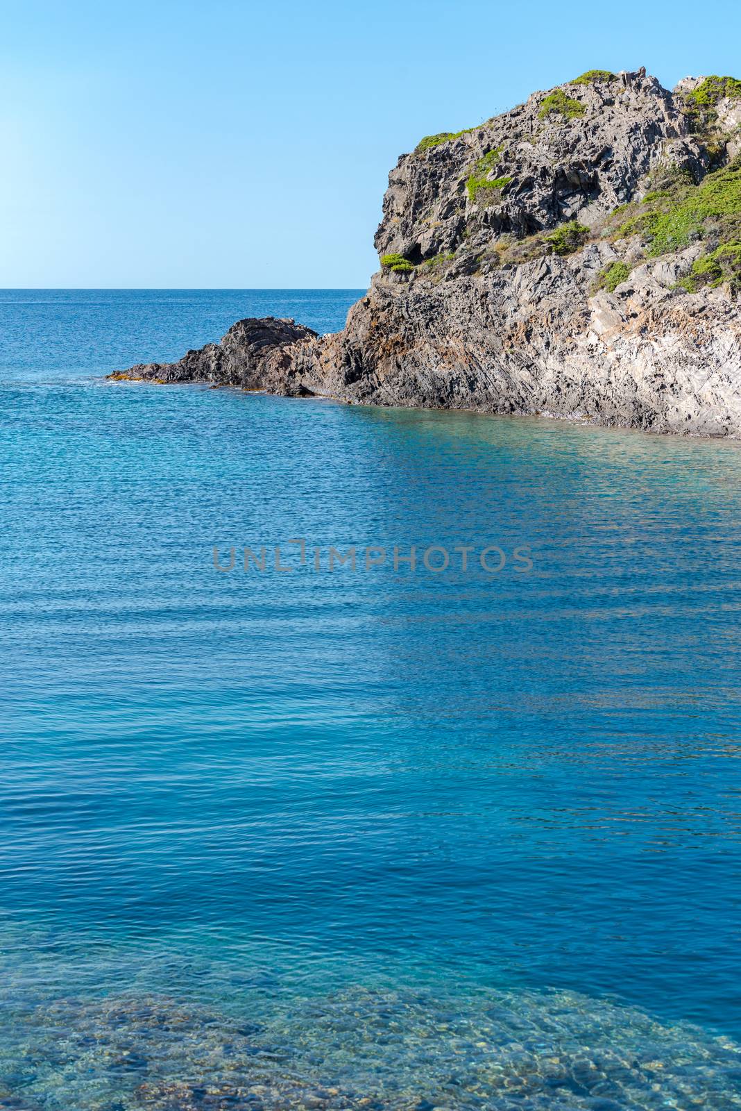 Sea landscape with Cap de Creus, natural park. Eastern point of Spain, Girona province, Catalonia. Famous tourist destination in Costa Brava. Sunny summer day with blue sky and clouds.