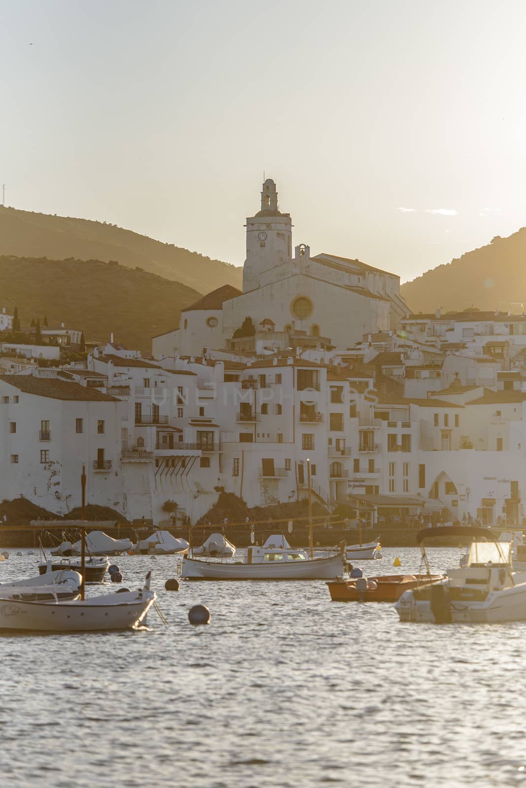 Cadaques, Spain : 07 JULY 2020 : Boats in the beach and houses of the village of Cadaques, Spain in summer on 07 july 2020.