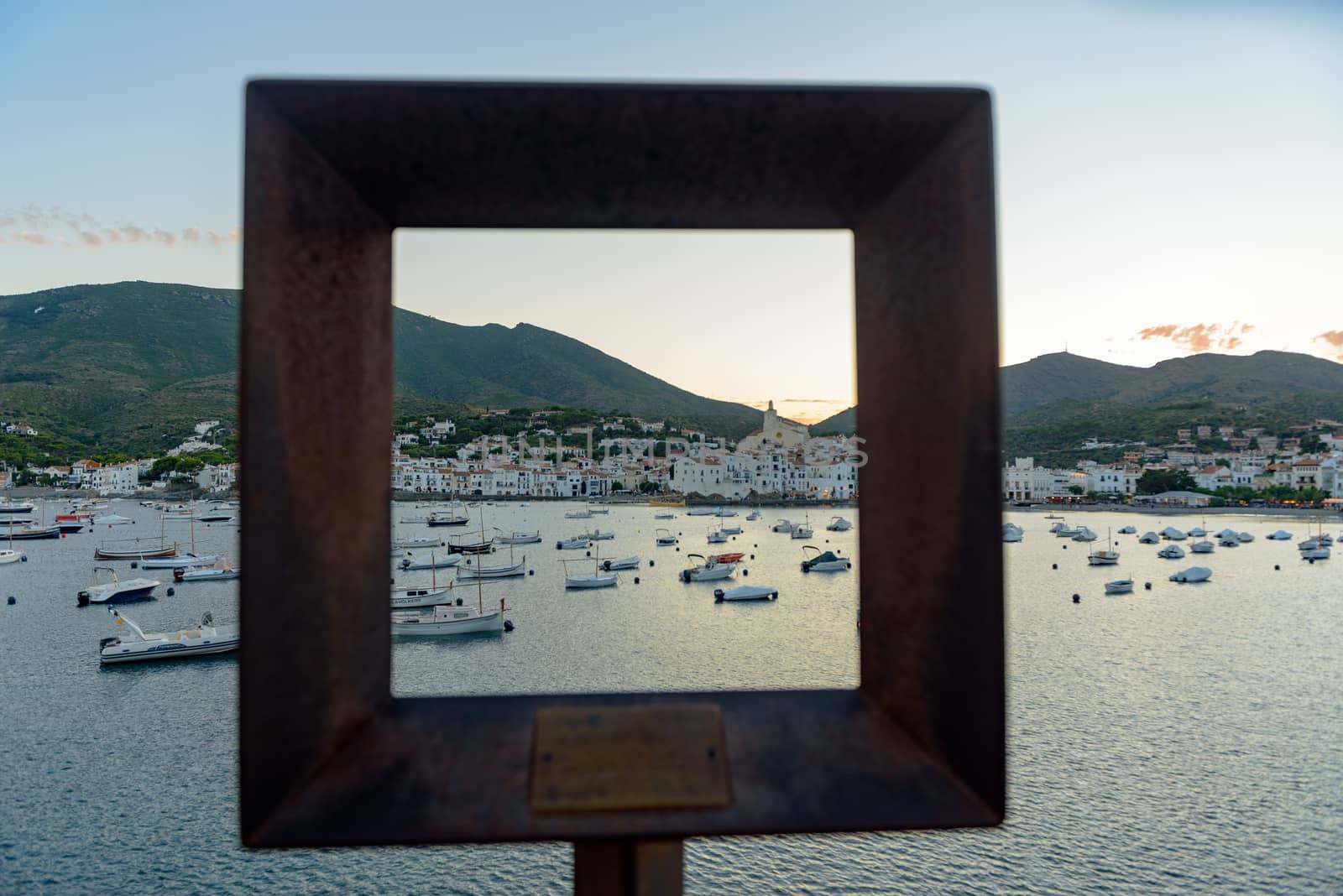 Boats in the beach and houses of the village of Cadaques, Spain.