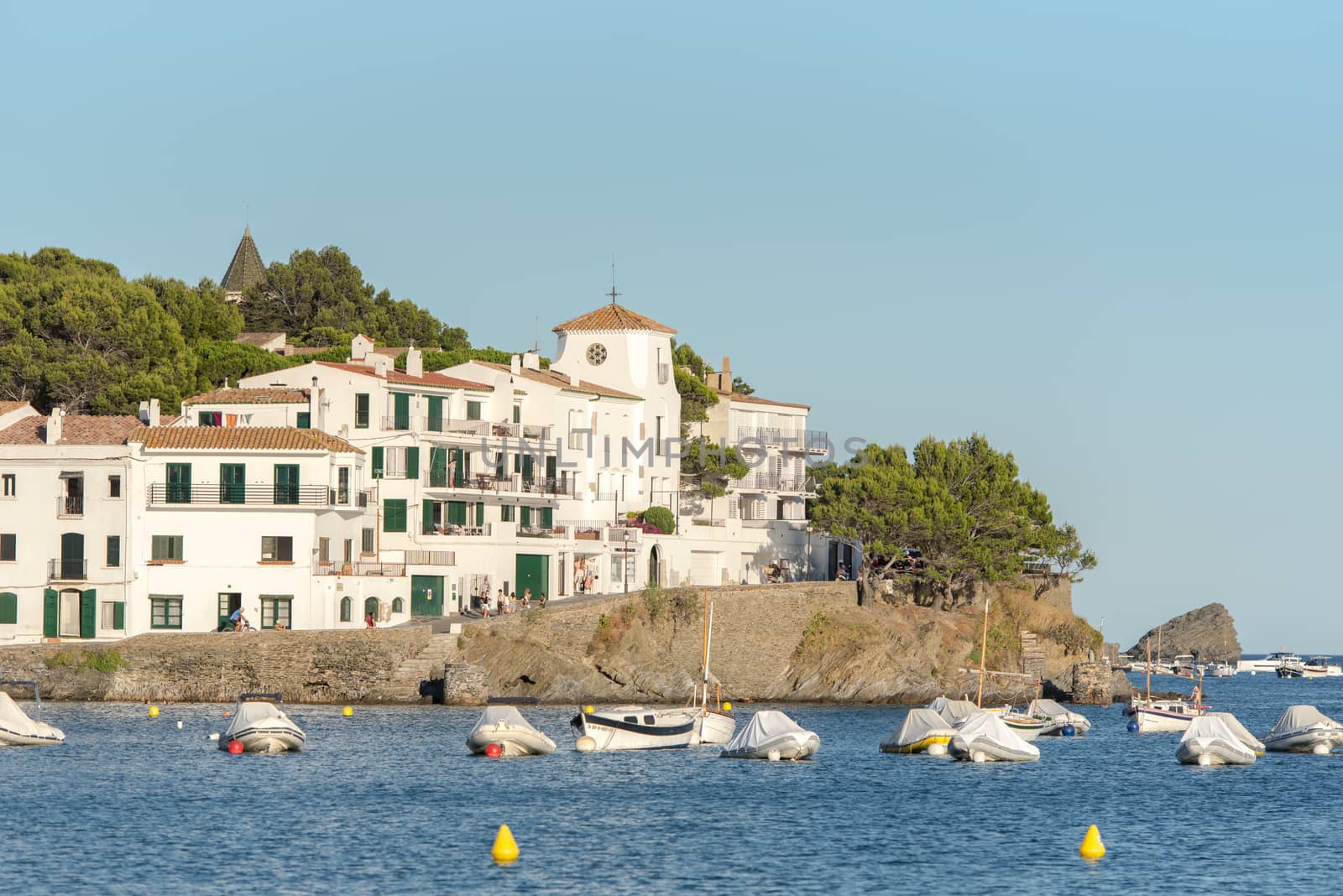 Cadaques, Spain : 07 JULY 2020 : Boats in the beach and houses of the village of Cadaques, Spain in summer on 07 july 2020.