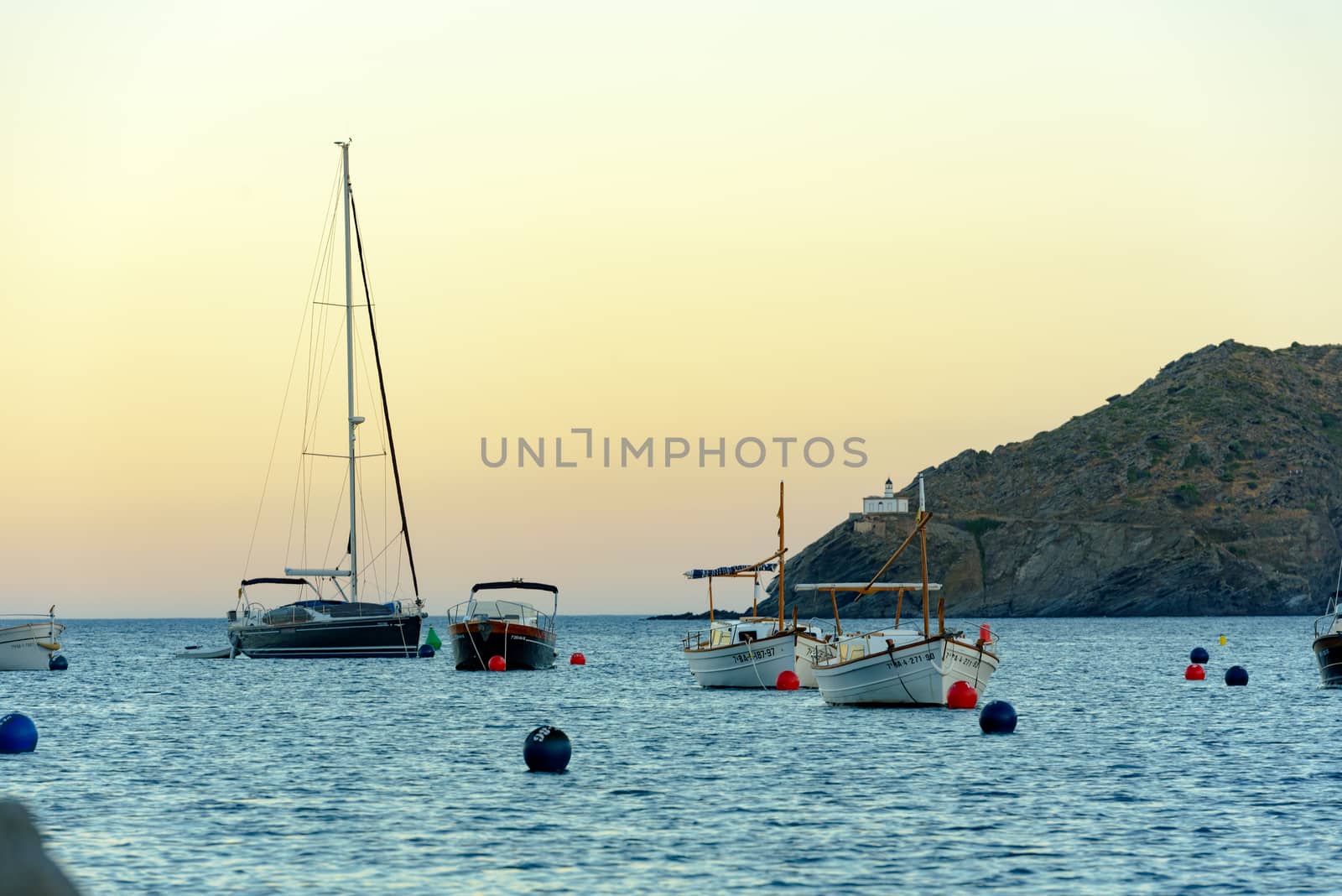 Cadaques, Spain : 07 JULY 2020 : Boats in the beach and houses of the village of Cadaques, Spain in summer on 07 july 2020.