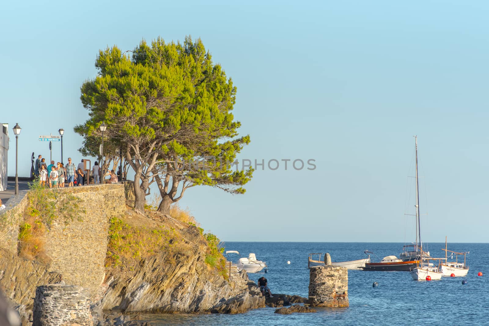 Boats in the beach and houses of the village of Cadaques, Spain  by martinscphoto