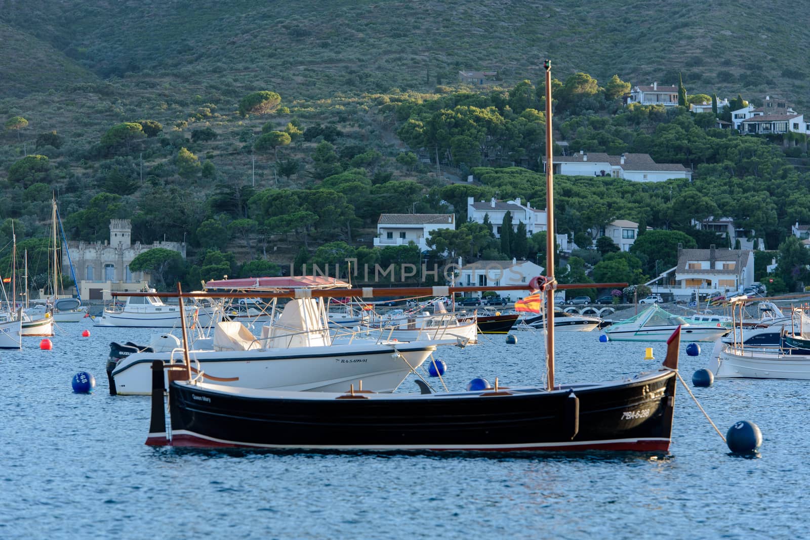 Cadaques, Spain : 07 JULY 2020 : Boats in the beach and houses of the village of Cadaques, Spain in summer on 07 july 2020.