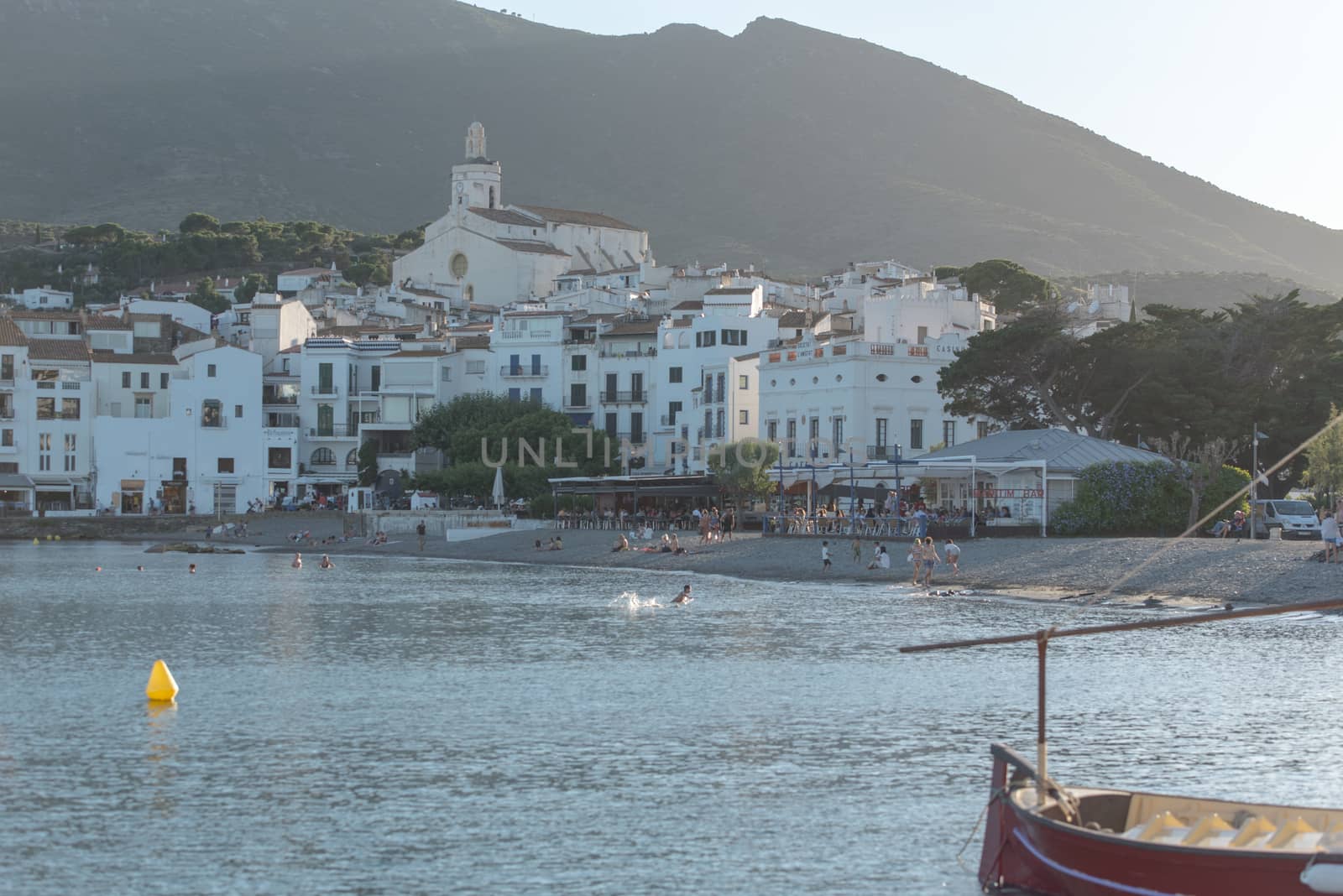 Cadaques, Spain : 07 JULY 2020 : Boats in the beach and houses of the village of Cadaques, Spain in summer on 07 july 2020.