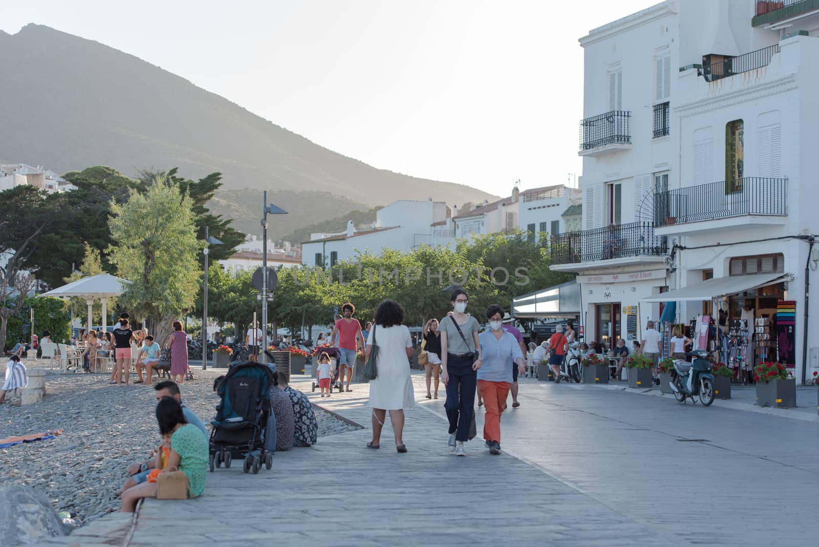 Cadaques, Spain : 07 JULY 2020 : People in the beach and houses of the village of Cadaques, Spain in summer on 07 july 2020.