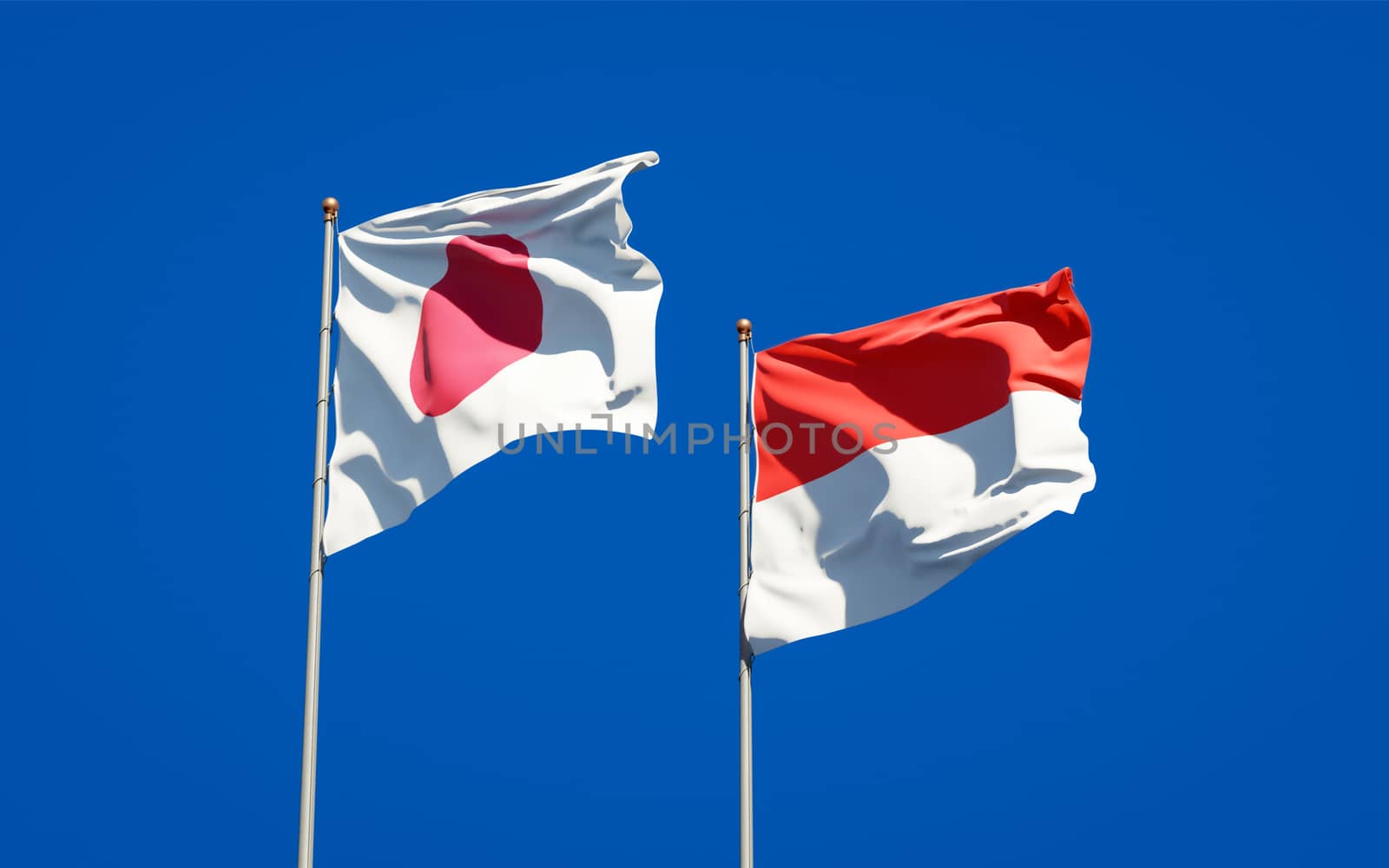 Beautiful national state flags of Japan and Indonesia together at the sky background. 3D artwork concept. 