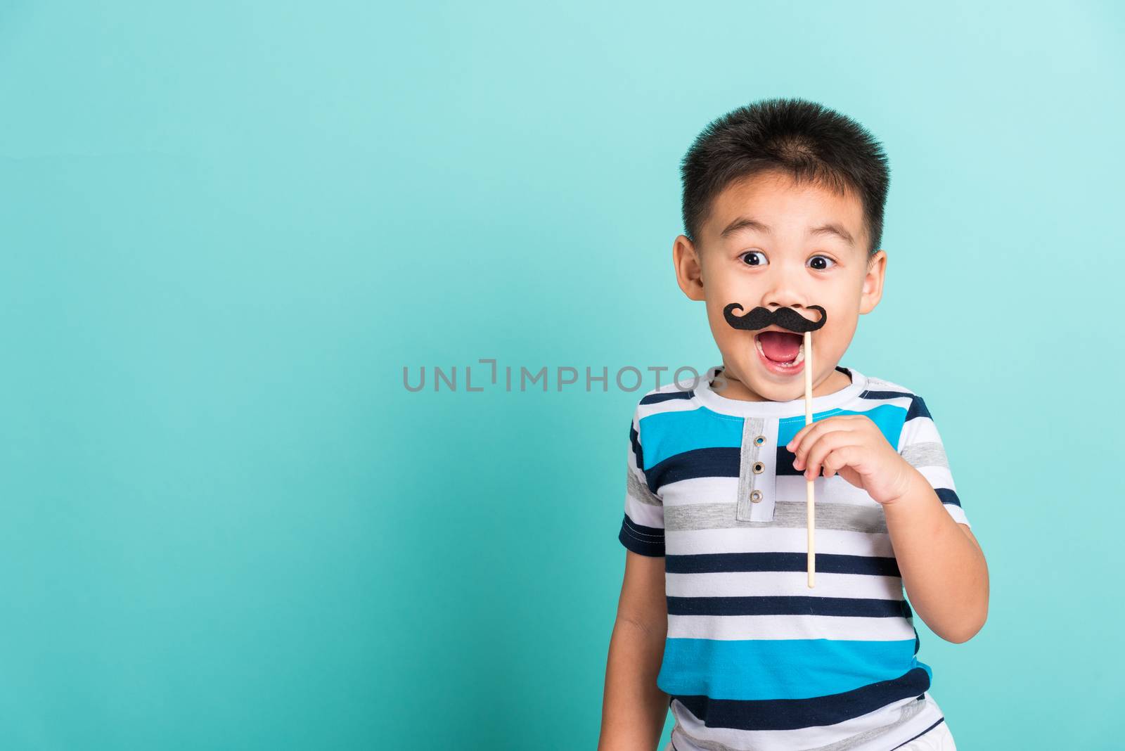 Funny happy hipster kid holding black mustache by Sorapop