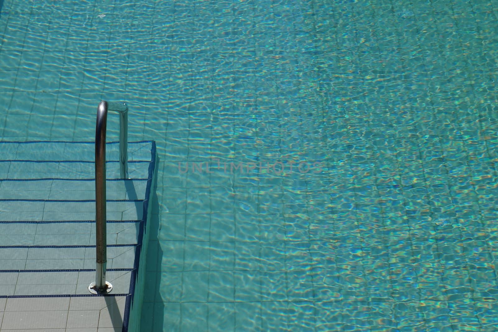 fragment of the pool with a ladder close up by Annado