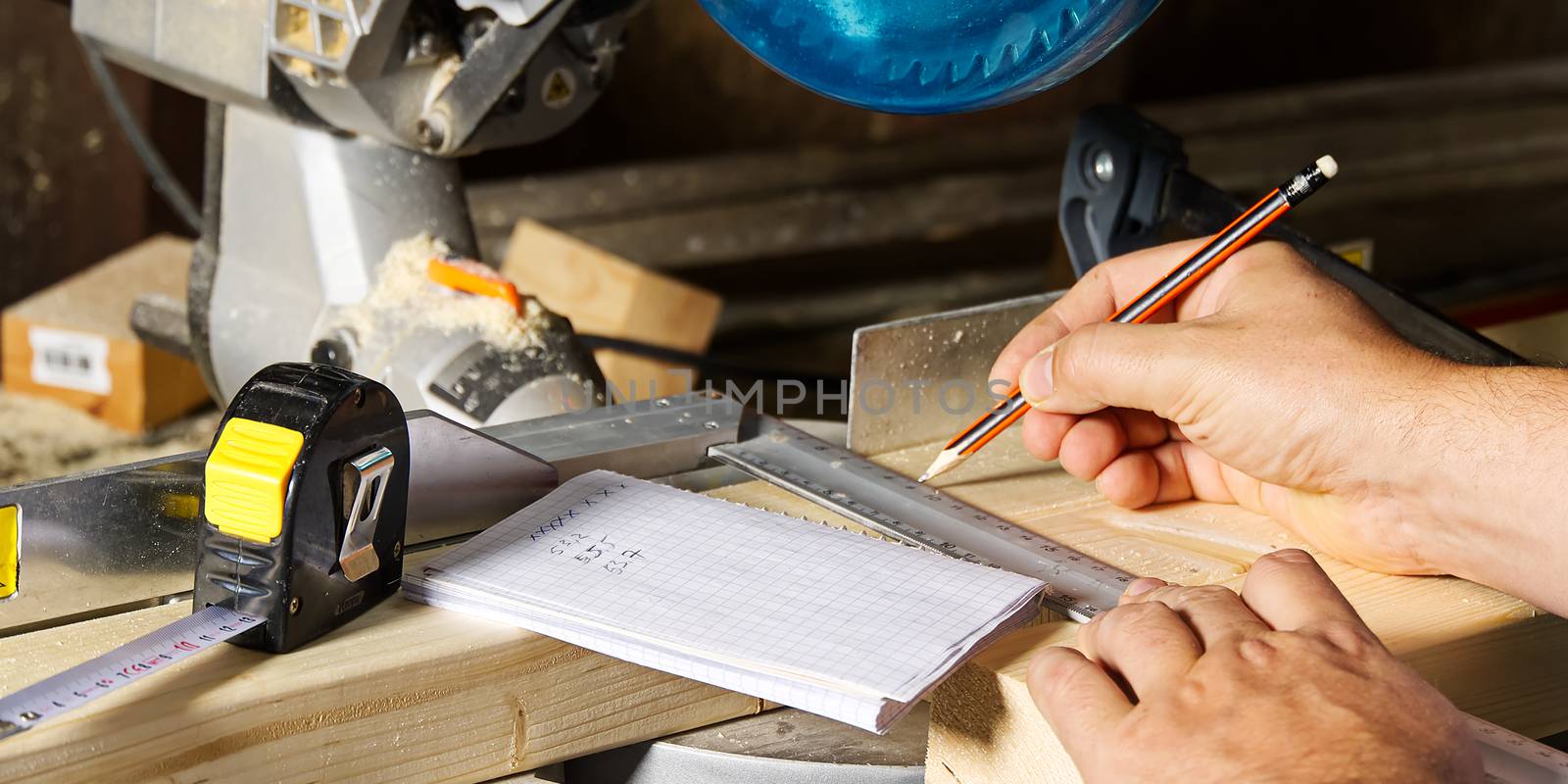 Carpenter work with circular saw for cutting wood bar, the man sawed bars, construction and home renovation. Carpenter work concept by PhotoTime