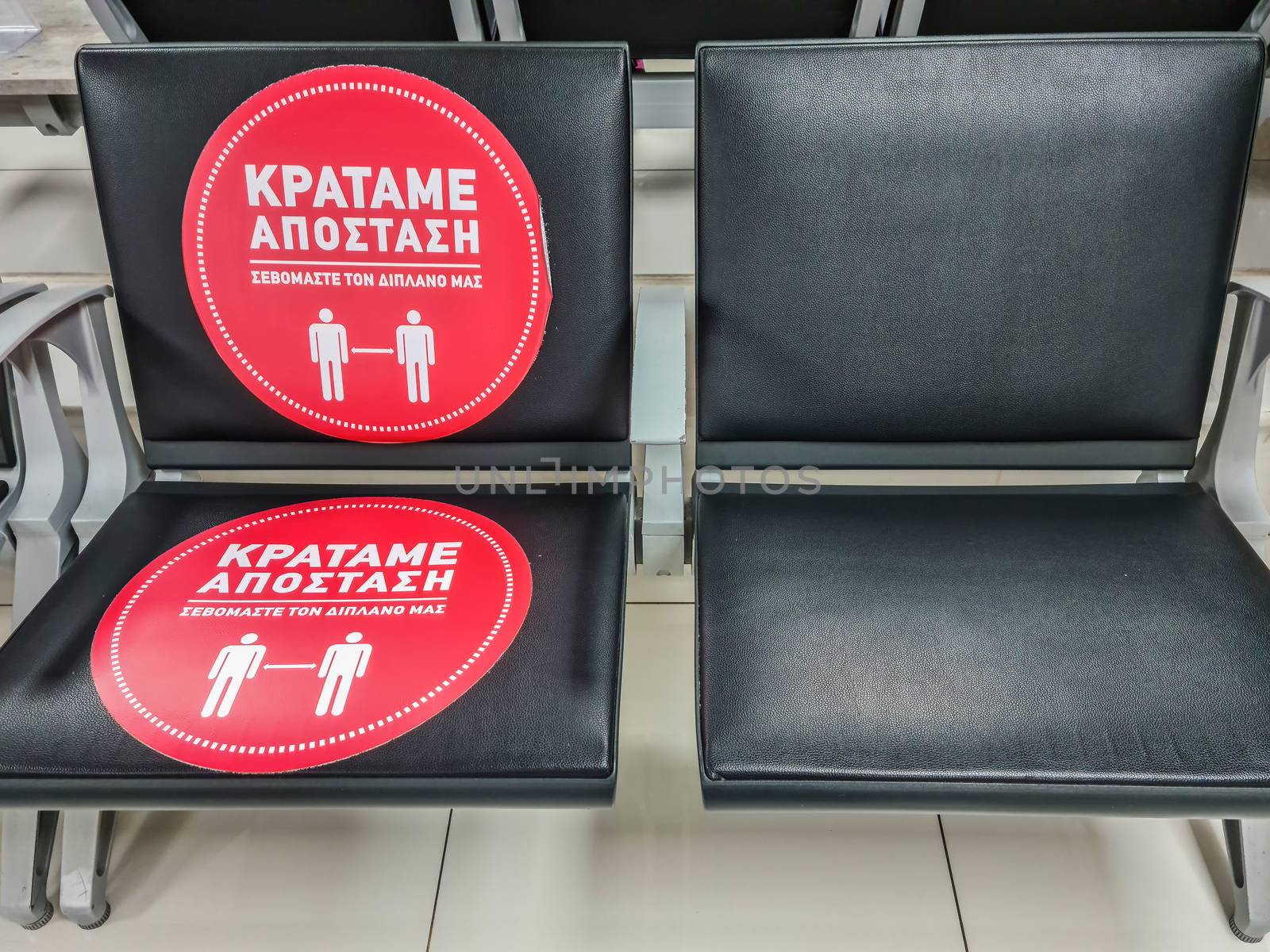 Chairs sticker suggesting customers keep 1.5 meters away as Coronavirus measures affect business & daily life.ssaloniki, Greece.