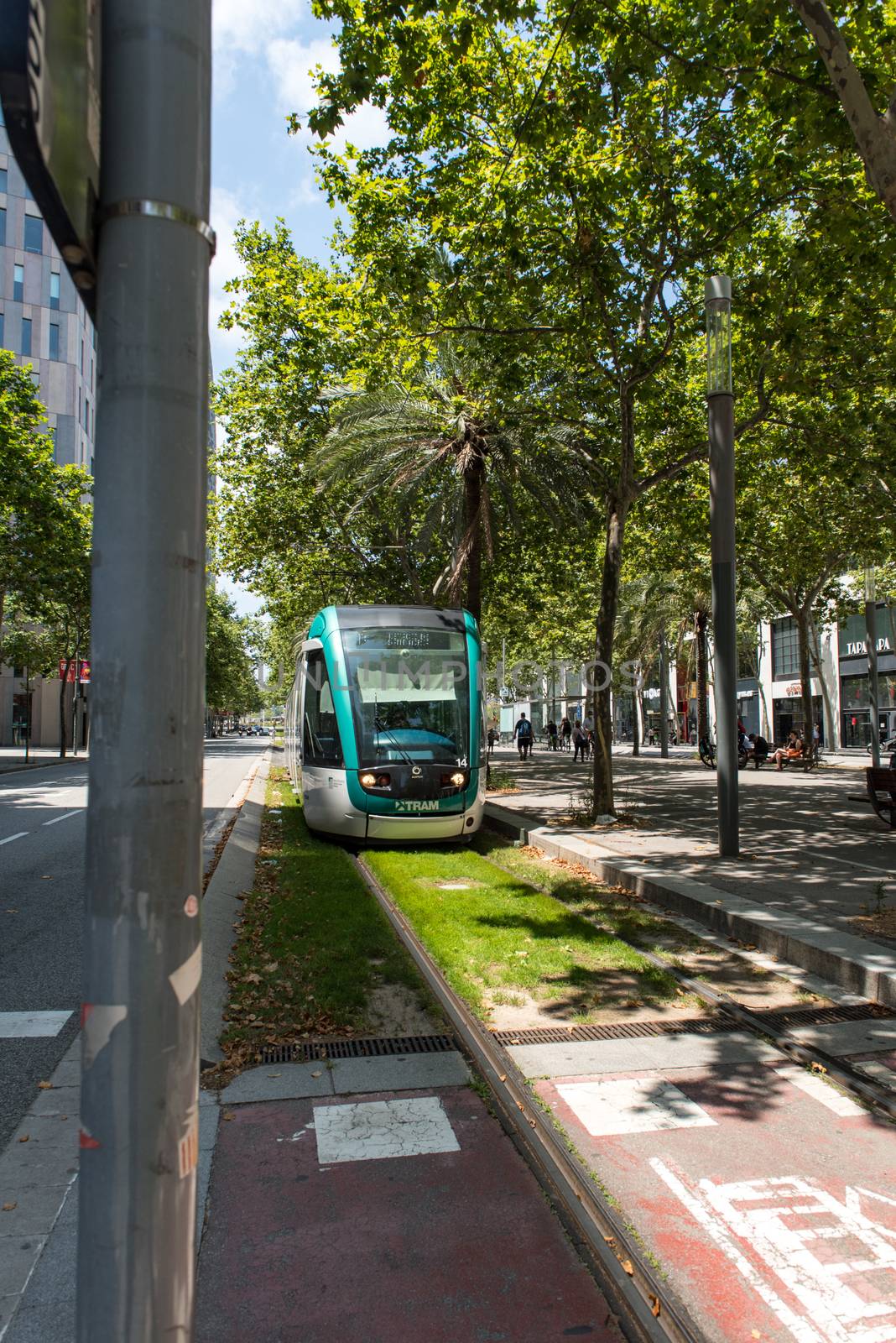 Barcelona, Spain - June 27 2020:  Train behind Glories shopping center is thought to be first shopping centers to have an open plan design incorporating outside space into its layout. behind Glories shopping center is thought to be first shopping centers to have an open plan design incorporating outside space into its layout.