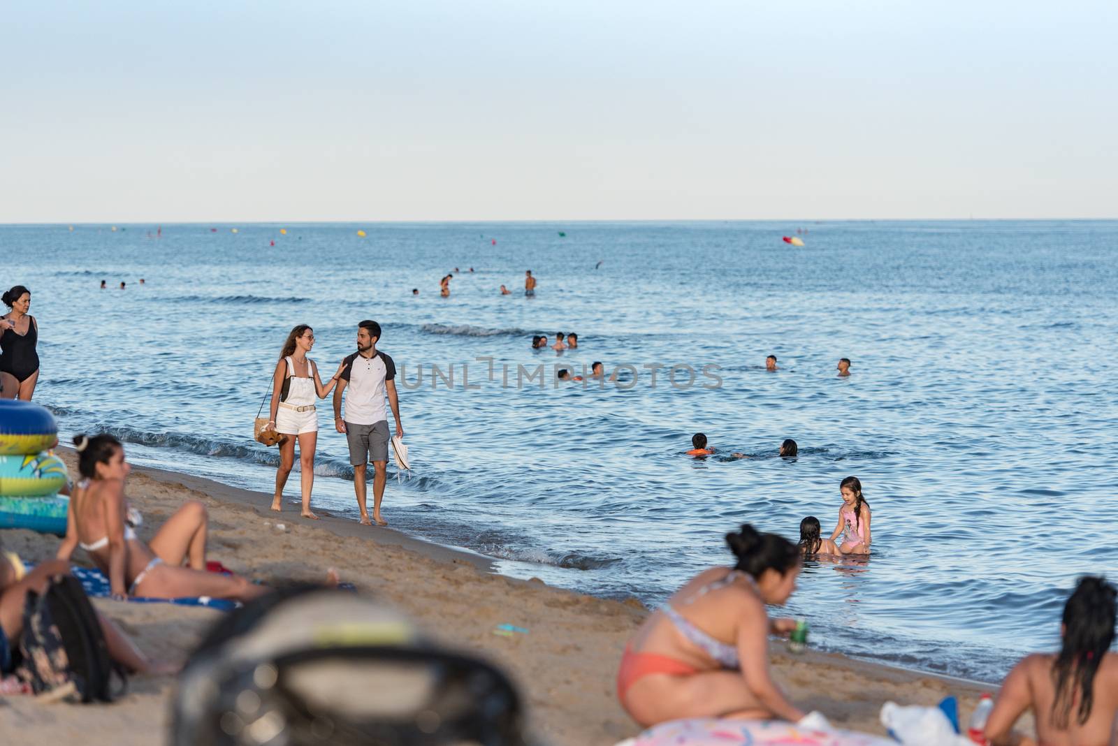 People in the beach of Castelldefels in Barcelona in summer afte by martinscphoto