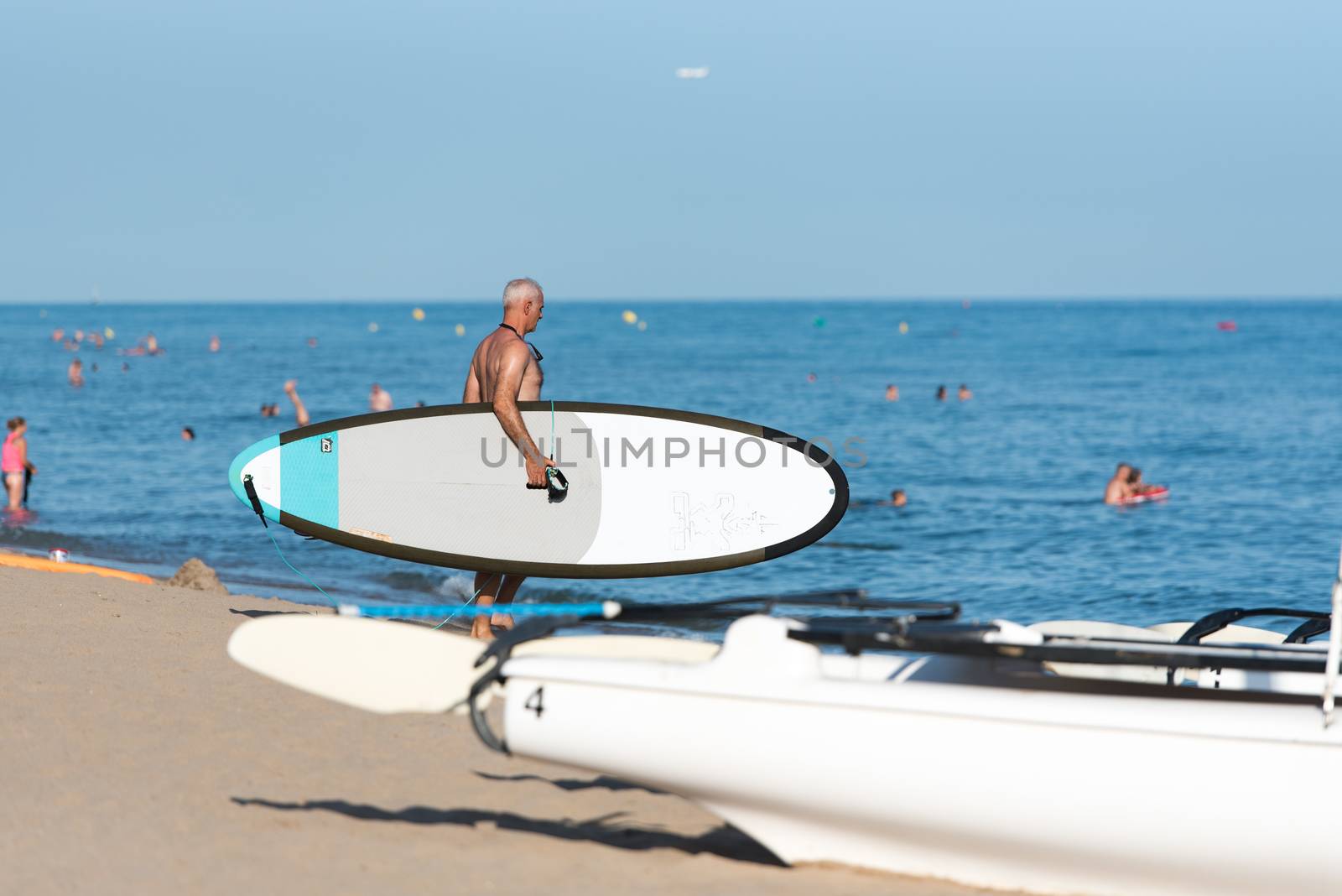 Castelldefels, Spain: 2020 June 25: People ride in Paddle Surf on the coast of Castelldefels in Barcelona in summer after COVID 19 on June 2020.