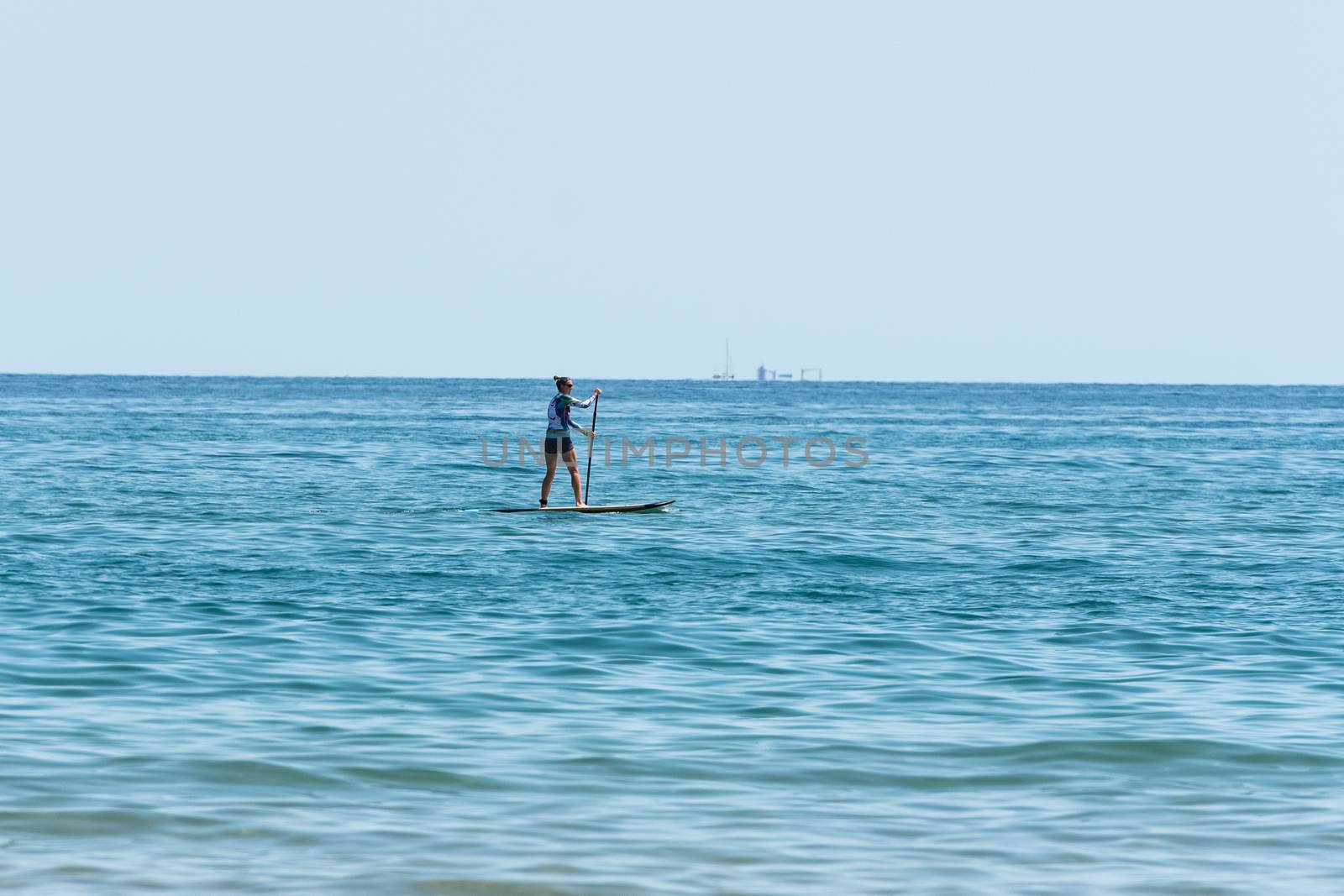 People ride in Paddle Surf on the coast of Castelldefels in Barc by martinscphoto