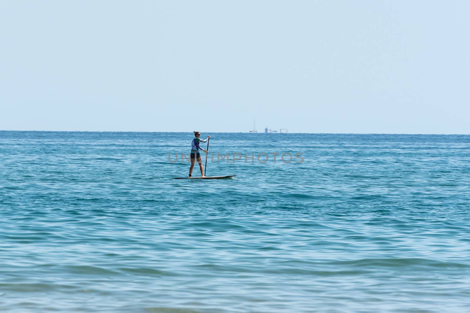 Castelldefels, Spain: 2020 June 25: People ride in Paddle Surf on the coast of Castelldefels in Barcelona in summer after COVID 19 on June 2020.