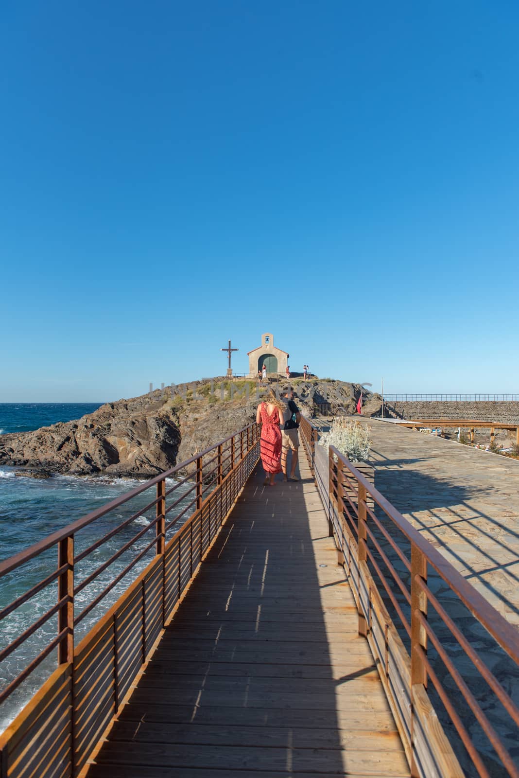 Colioure, France - July 21, 2020: Tourists near chapel of Saint Vincent in sea of Collioure in south of France.