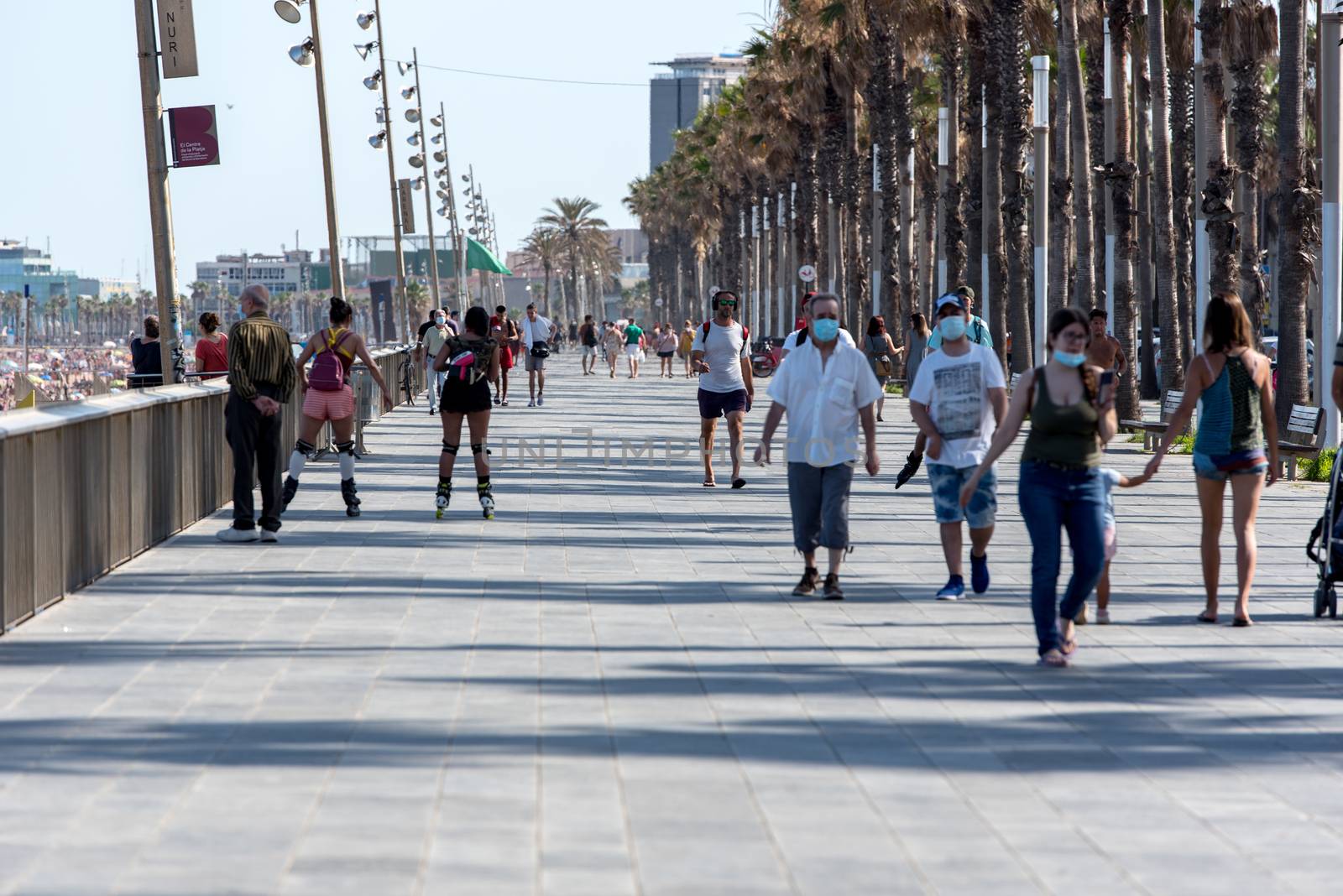 People Wal k Barceloneta Beach with Frank Gehry's Peix d'Or (Wha by martinscphoto