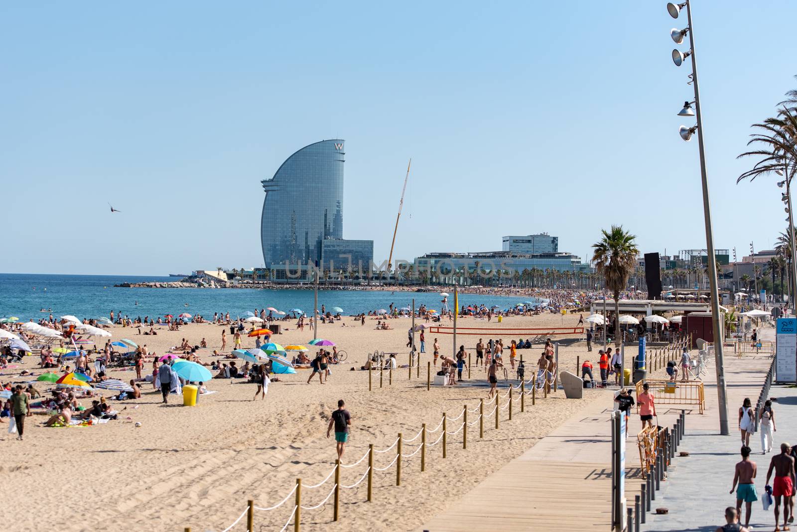 BARCELONA - JUNE 26, 2020: Barceloneta beach with people in summer after COVID 19 on June 26, 2020 in Barcelona, ​​Spain.