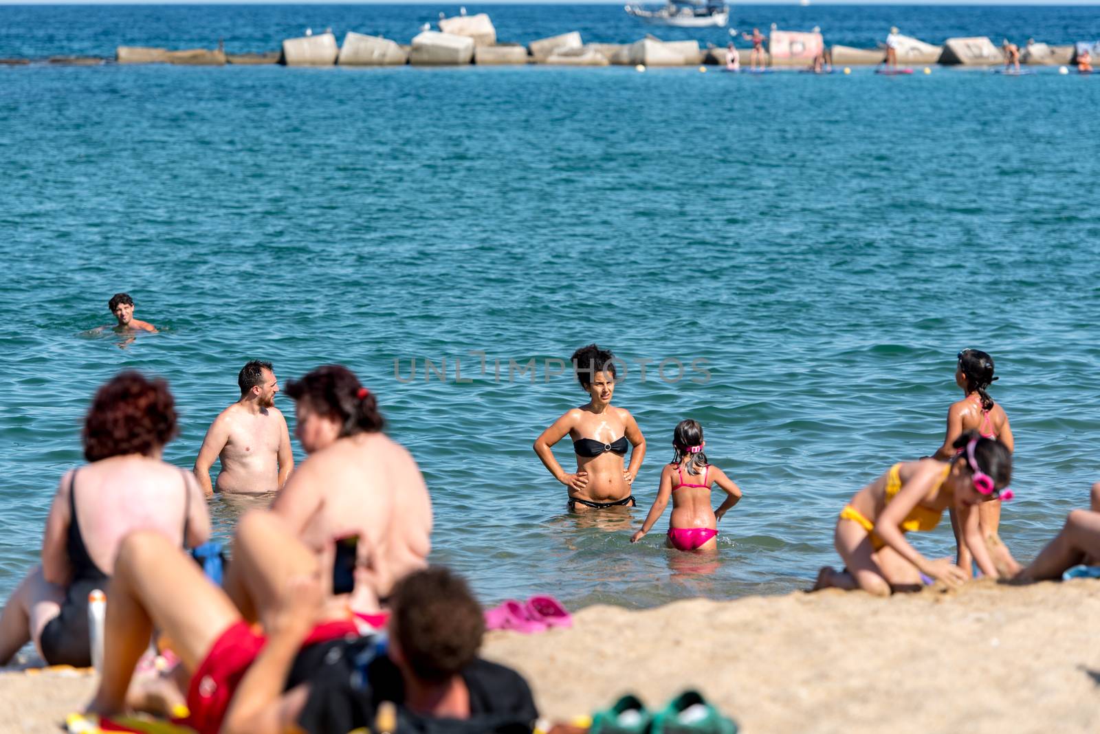 BARCELONA - JUNE 26, 2020: Barceloneta beach with people in summer after COVID 19 on June 26, 2020 in Barcelona, ​​Spain.