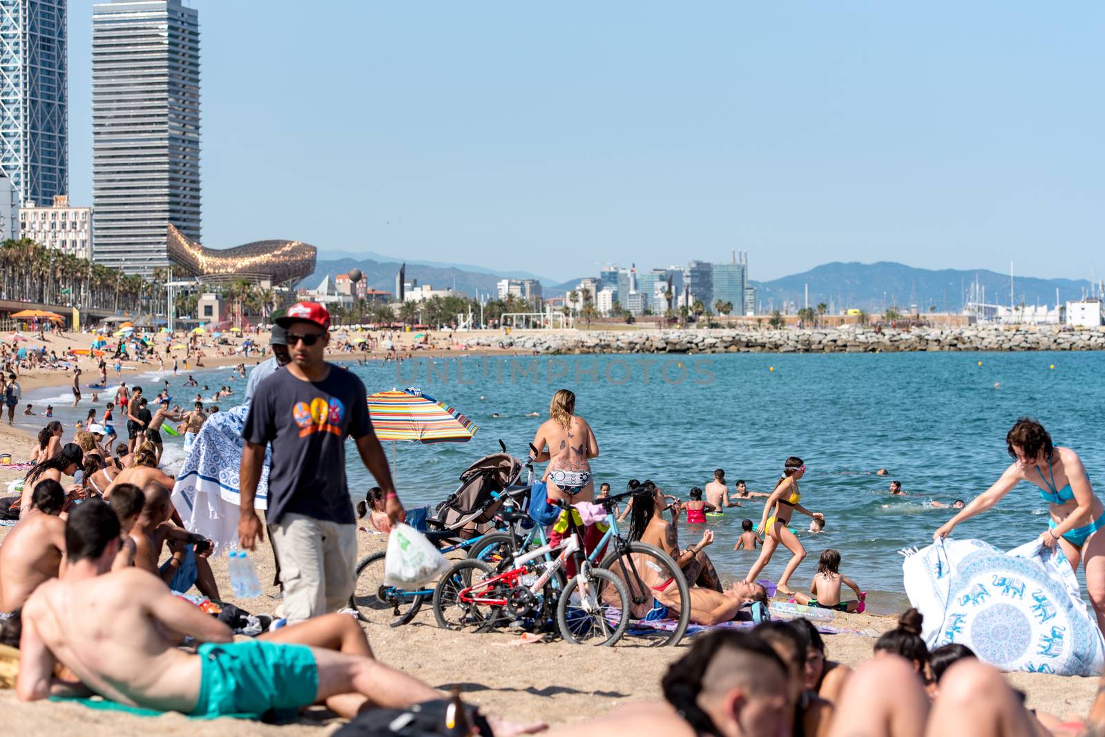 BARCELONA - JUNE 26, 2020: Barceloneta beach with people in summer after COVID 19 on June 26, 2020 in Barcelona, ​​Spain.