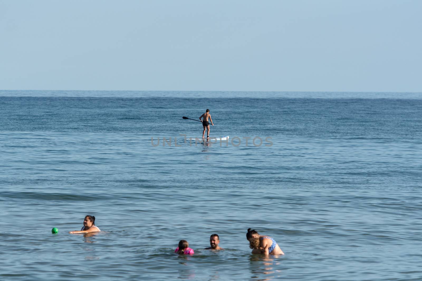 Castelldefels, Spain: 2020 June 25: People ride in Paddle Surf on the coast of Castelldefels in Barcelona in summer after COVID 19 on June 2020.