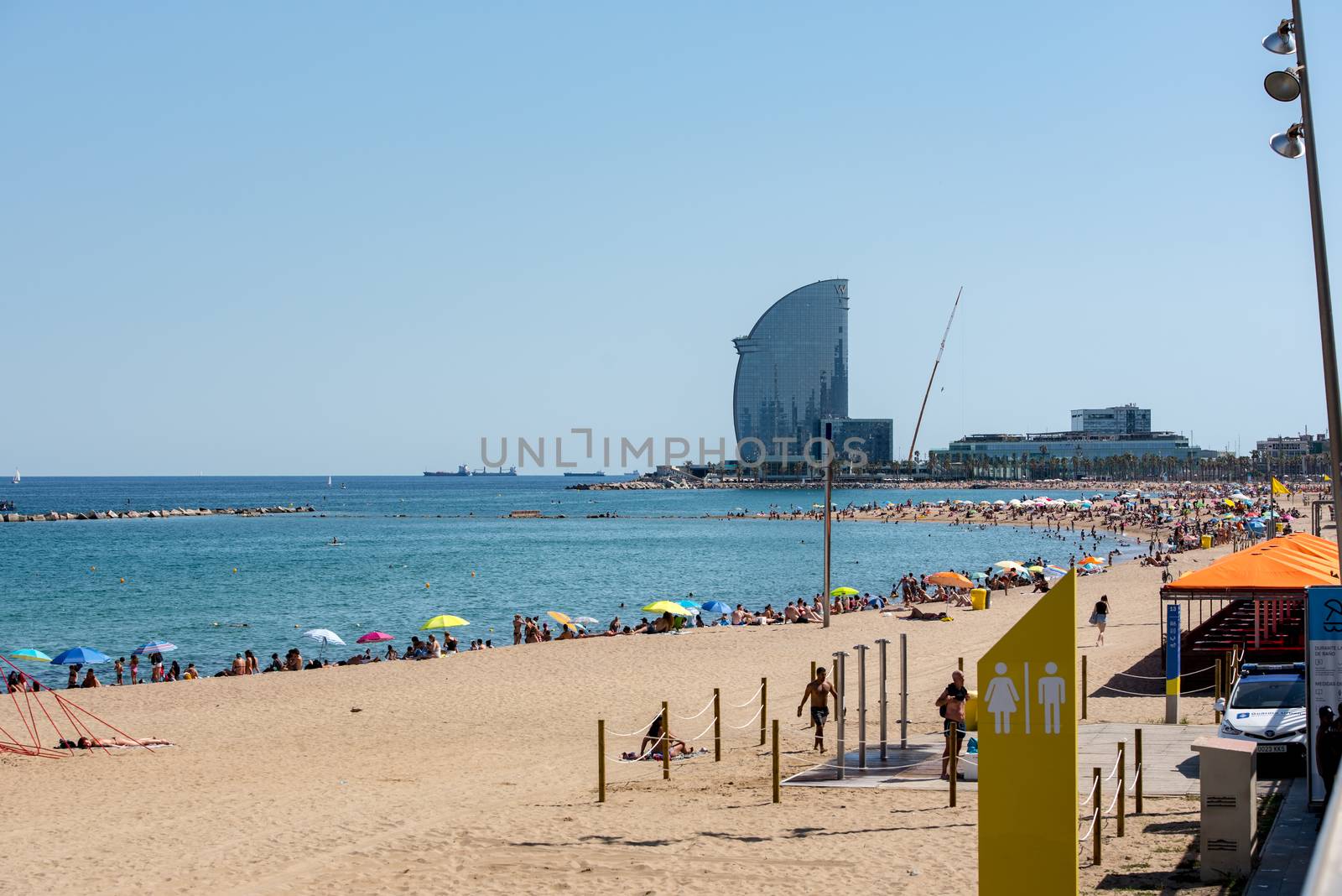 BARCELONA - JUNE 26, 2020: Barceloneta beach with people in summer after COVID 19 on June 26, 2020 in Barcelona, ​​Spain.