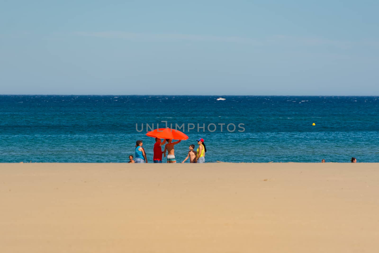 Canet en Roussillon, France: June 21, 2020: People in the beach. Sunny day in the tourist town of Canet en Roussillion in France on the Mediterranean Sea.