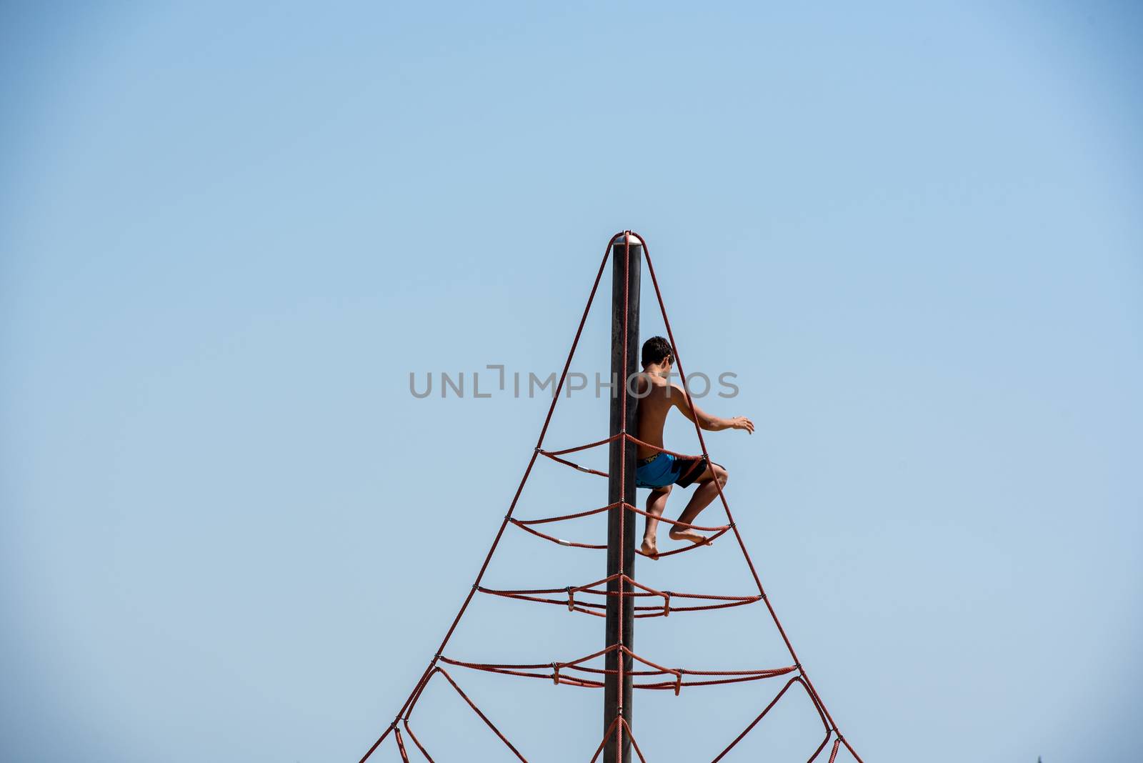 BARCELONA - JUNE 26, 2020: Children play in Barceloneta beach with people in summer after COVID 19 on June 26, 2020 in Barcelona, ​​Spain.