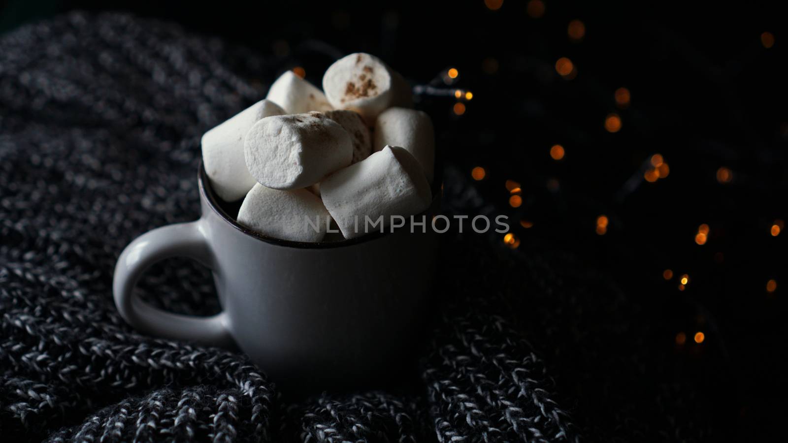 Hot cocoa with marshmallow in a white ceramic mug. The concept of cosy holidays and New Year.