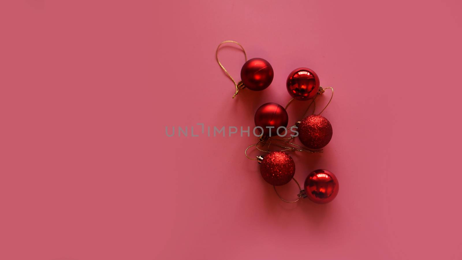 Six Christmas red balls on pink background