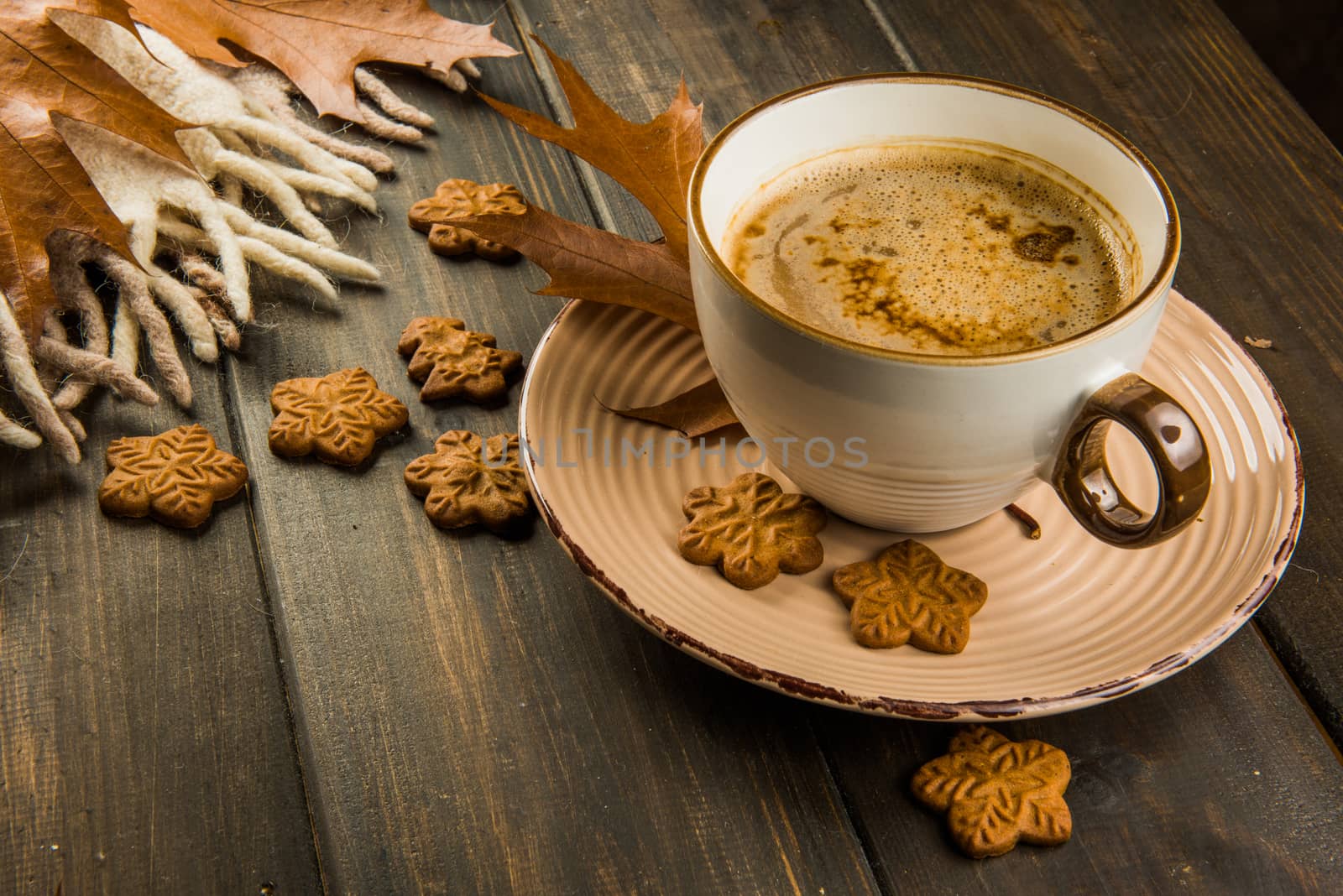 Cup of hot coffee on Christmas and sweet cookies, plaid with brown oak leaves top view on wooden background