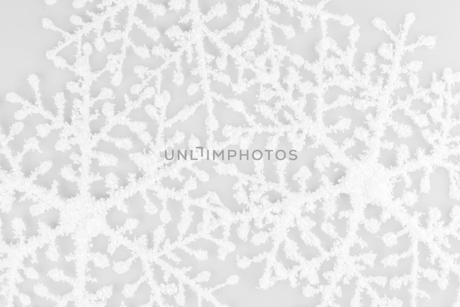 White Snowflakes on isolated on white background. Christmas composition. Frame made of white snowflakes on white background.