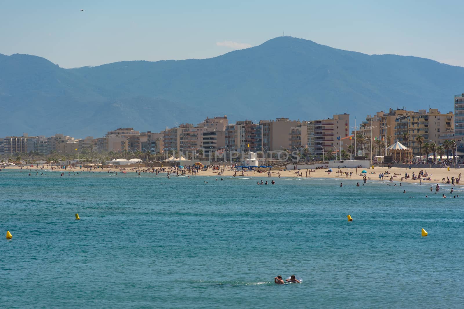 Canet en Roussillon, France: June 21, 2020: People in the beach. Sunny day in the tourist town of Canet en Roussillion in France on the Mediterranean Sea.