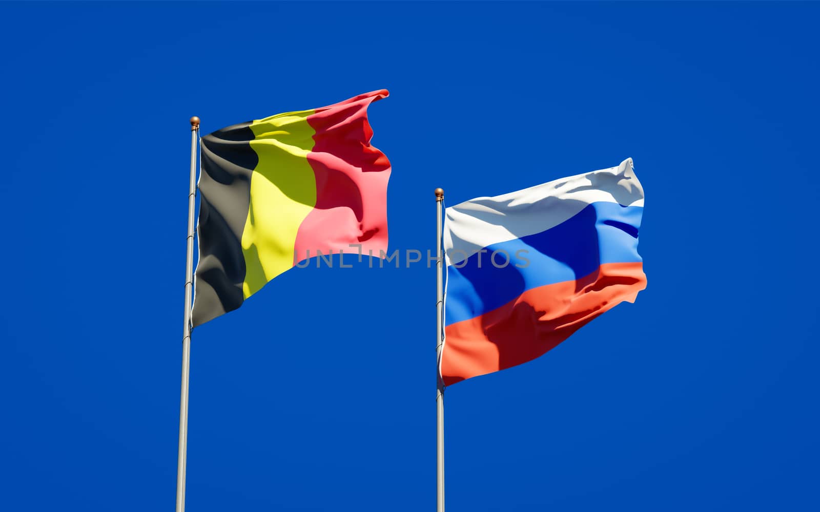 Beautiful national state flags of Russia and Belgium together at the sky background. 3D artwork concept. 