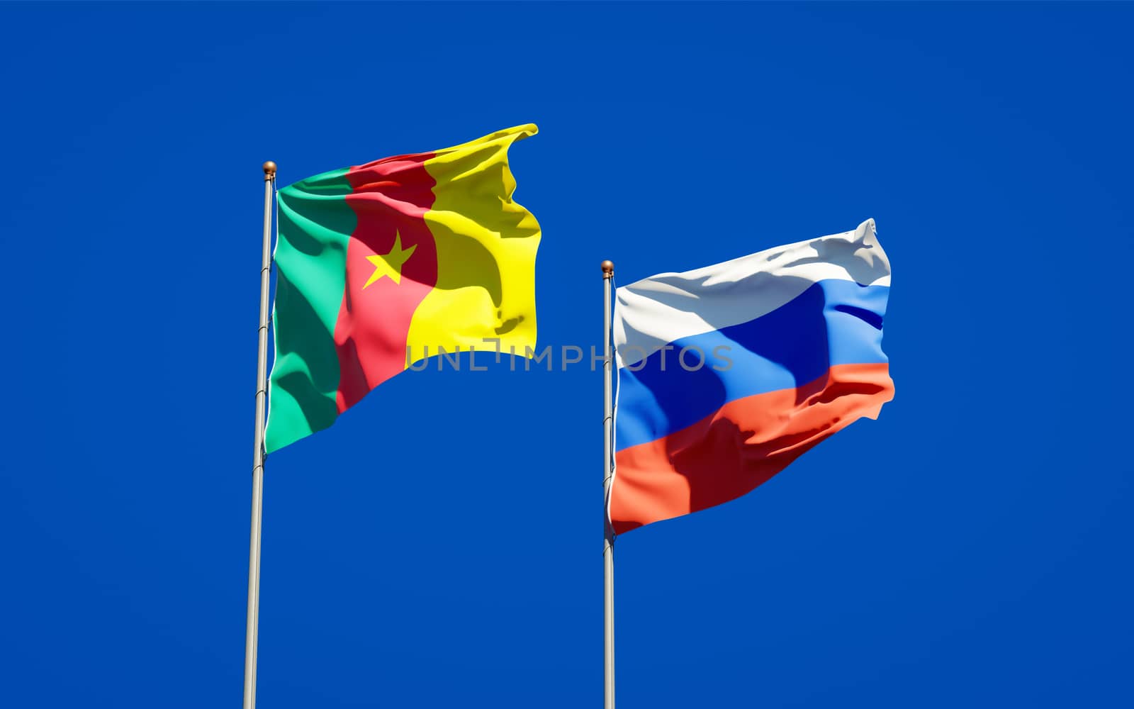 Beautiful national state flags of Russia and Cameroon together at the sky background. 3D artwork concept. 