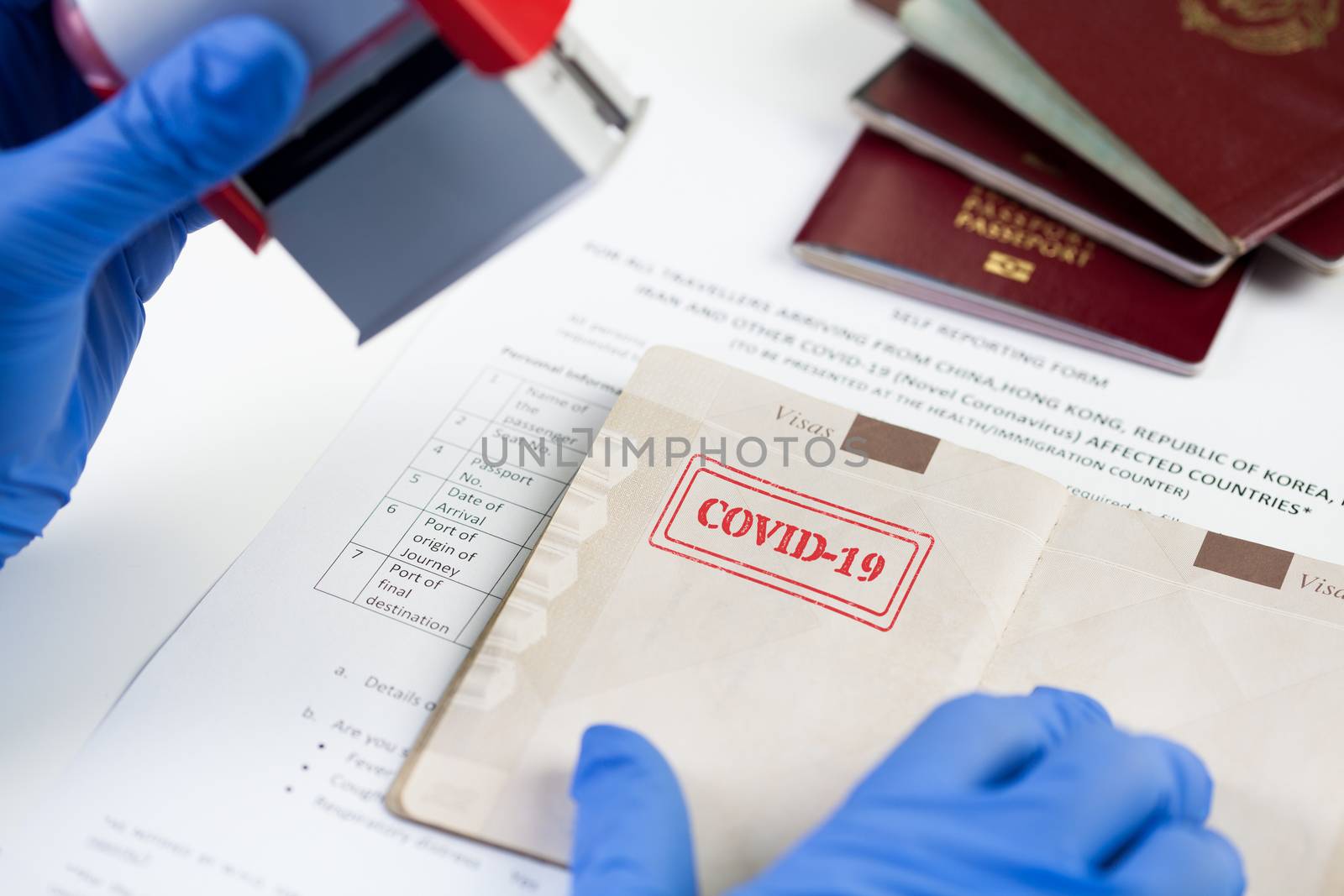COVID-19 stamped in passport,airport border customs health and safety security check,restrictive no entry measures due to COVID-19 corona virus disease epidemic,Coronavirus global pandemic,US & UK 