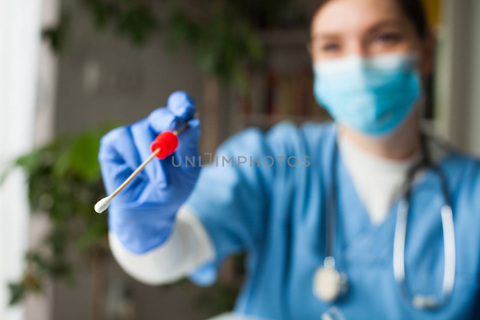 rt-PCR COVID-19 virus disease diagnostic test,lab technician wearing blue protective gloves holding test tube with swabbing stick,swab sample equipment kit & CDC form specimen submitting guidelines