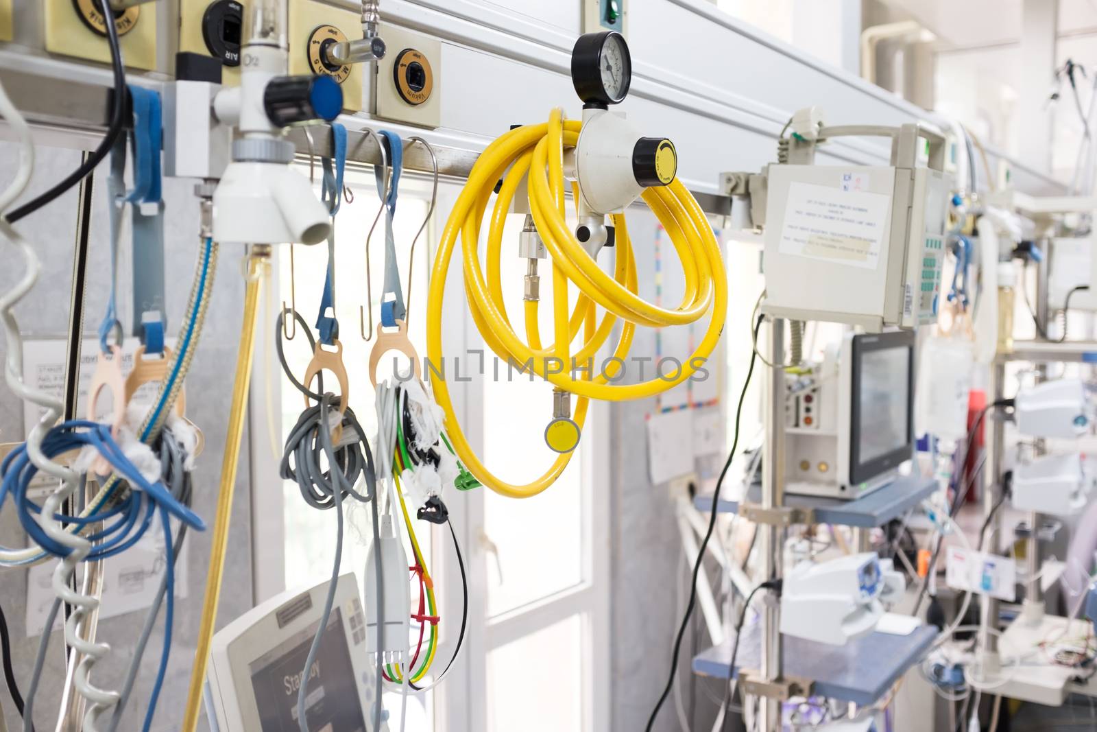 Medical equipment in UK NHS hospital emergency room, yellow pipe hose & healthcare devices on rack in background,surgery department,corona virus COVID-19 epidemic pandemic crisis high death toll rate