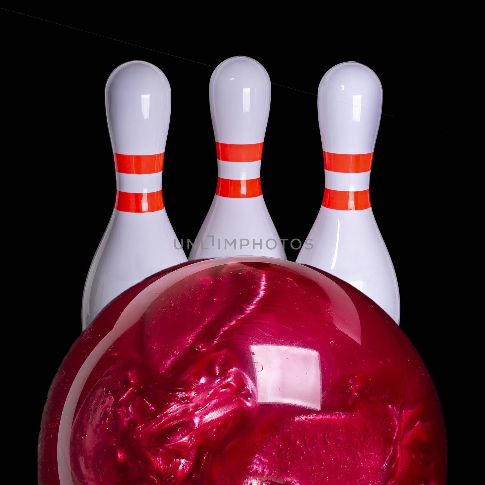 Bowling sport. Red ball and three bowling pins of on black background by 977_ReX_977