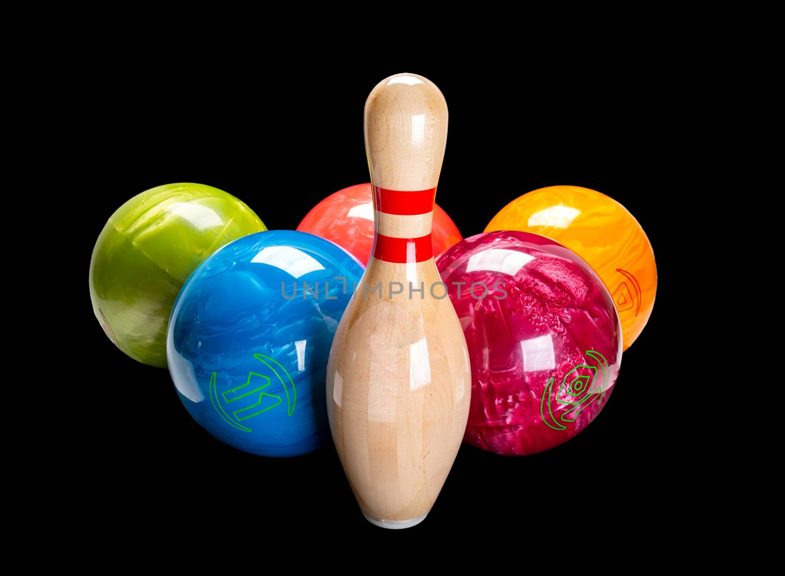 Wooden pin for bowling isolated on a black background. Bowling multi-colored ball.