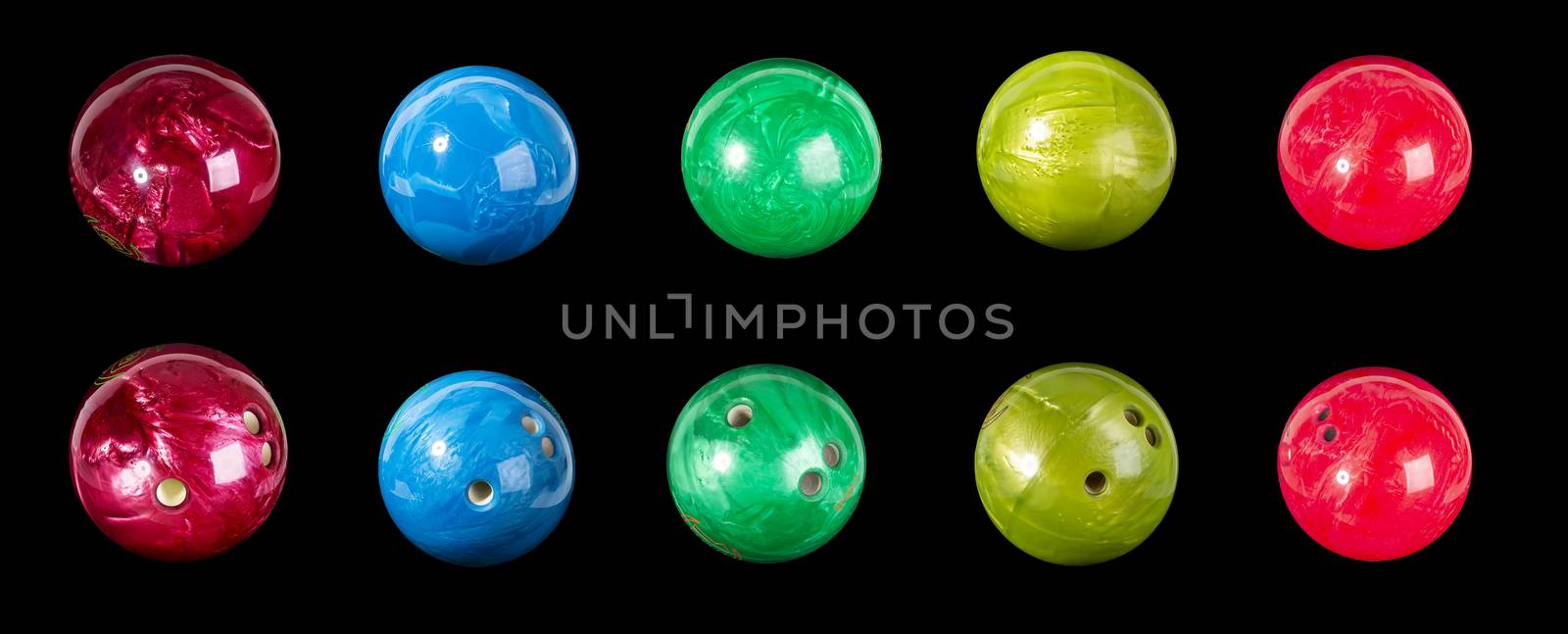 Set of colorful balls for bowling red blue light green. Isolated on a black background close-up.