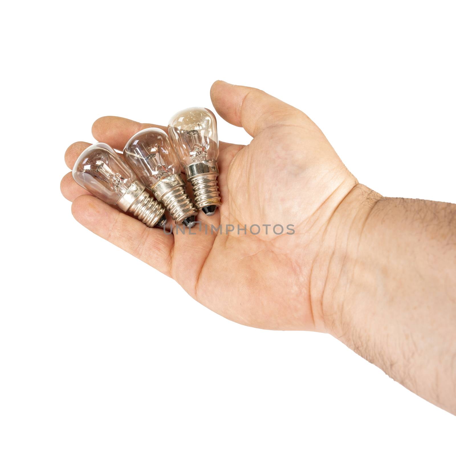 Some old tungsten incandescent lamp in hand. Isolated image on a white background.