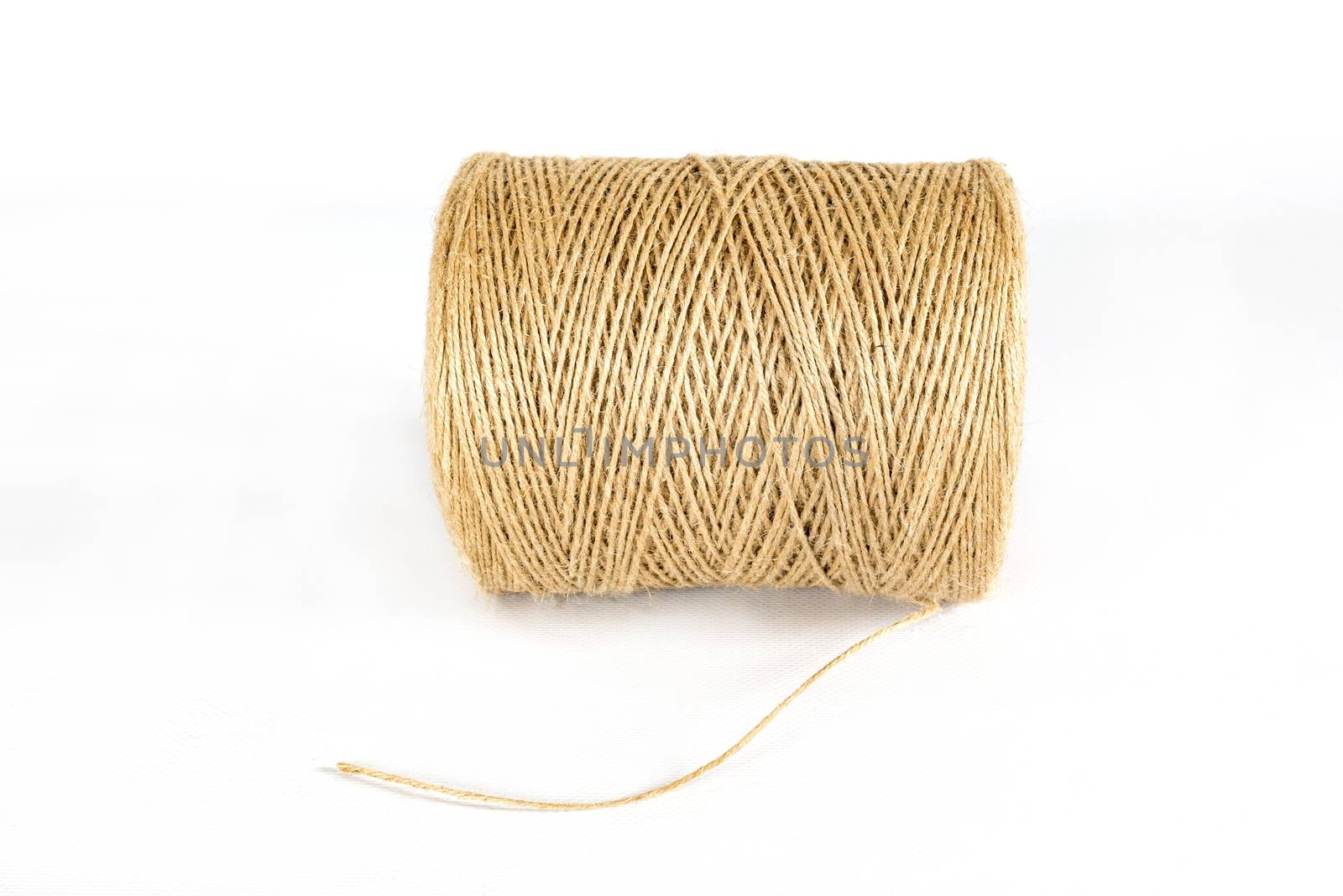 Hank of a hemp rope bobbin. Close-up isolated on a white background.